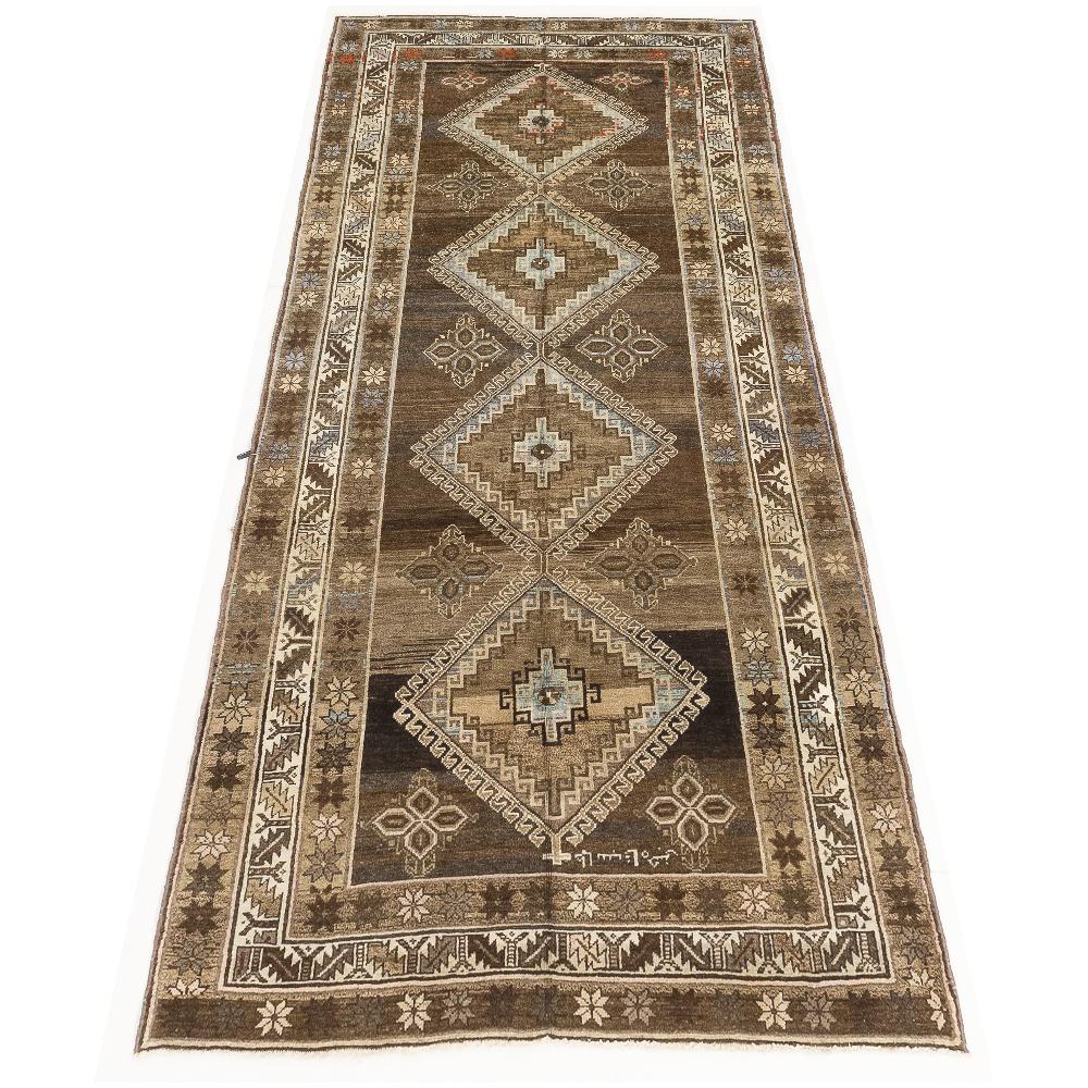 Antique Persian runner rug handwoven from the finest sheep’s wool and colored with all-natural vegetable dyes that are safe for humans and pets. It’s a traditional Malayer design featuring brown and gray geometric details over an ivory field. It’s a