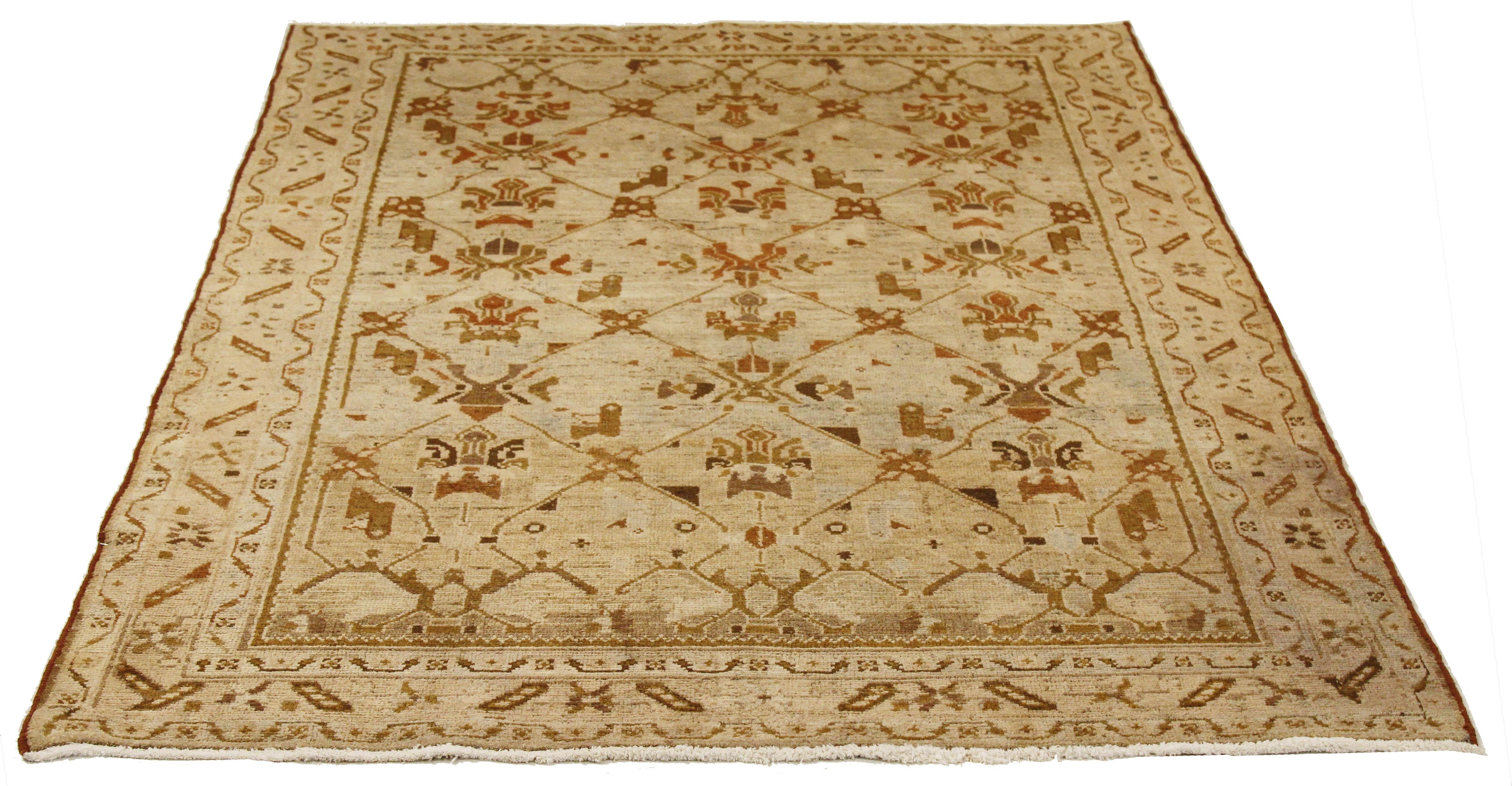 Antique Persian rug handwoven from the finest sheep’s wool and colored with all-natural vegetable dyes that are safe for humans and pets. It’s a traditional Malayer design featuring green and brown botanical details all-over an ivory field. It’s a