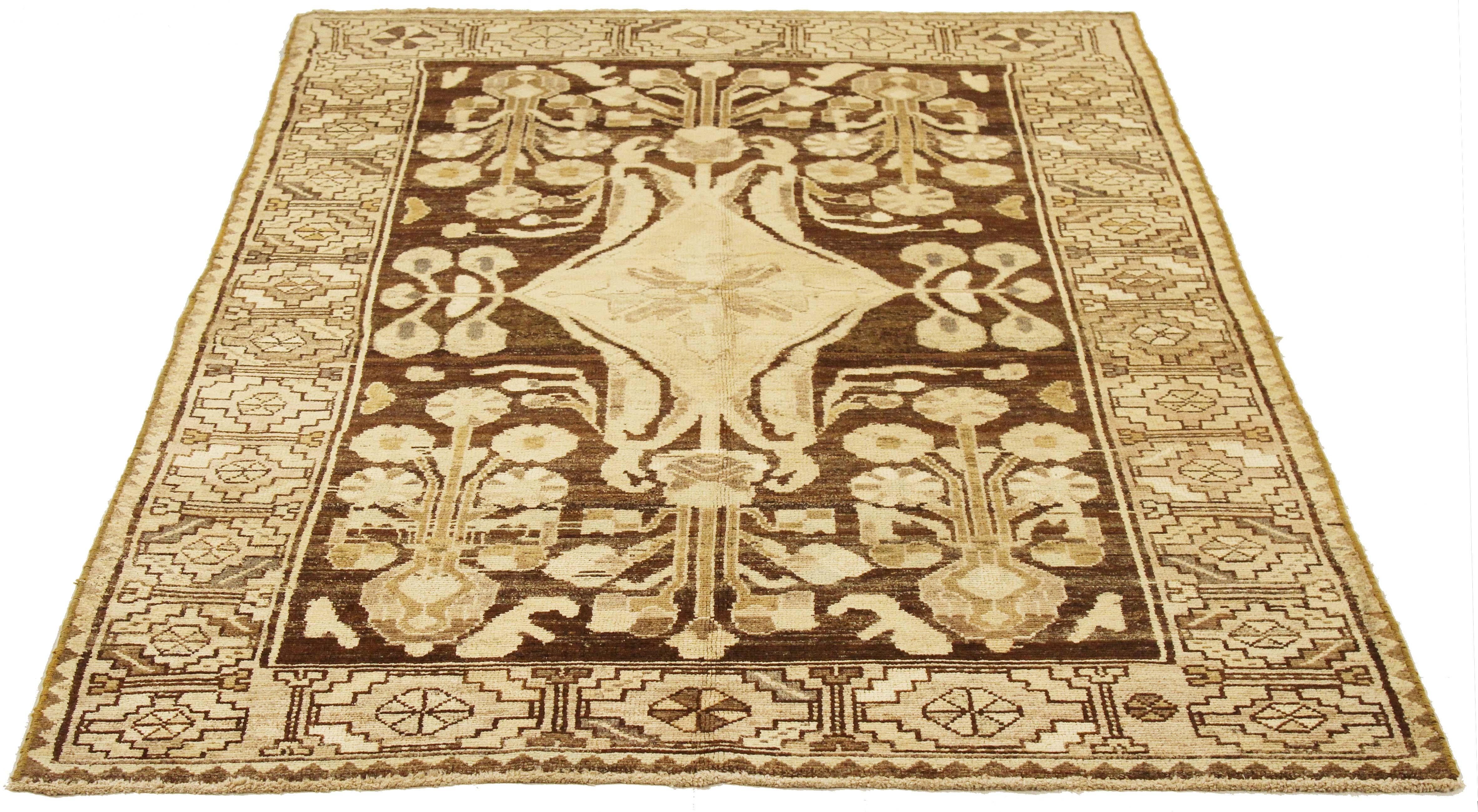 Antique Persian rug handwoven from the finest sheep’s wool and colored with all-natural vegetable dyes that are safe for humans and pets. It’s a traditional Malayer design featuring ivory and beige botanical details over a brown field. It’s a lovely