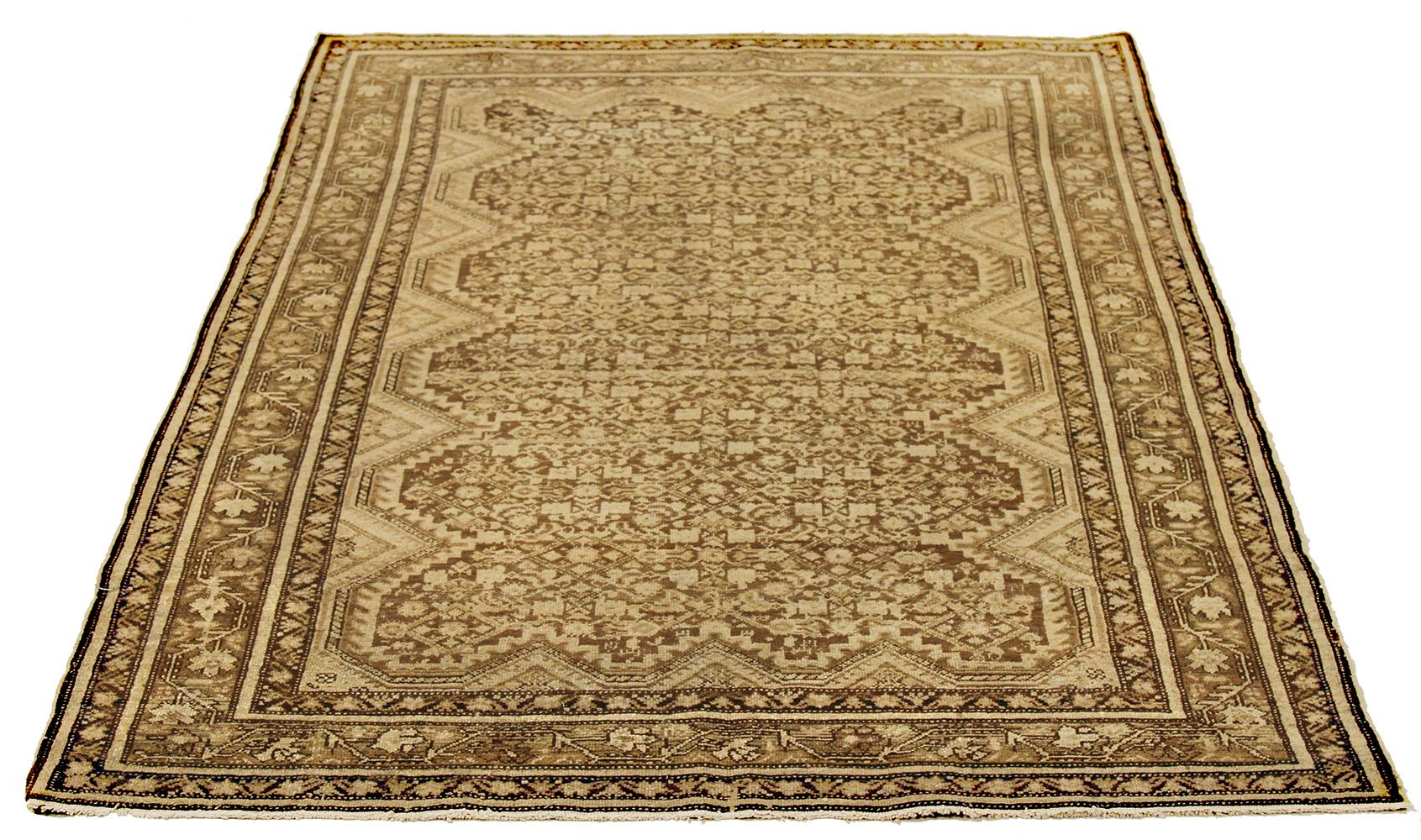 Antique Persian runner rug handwoven from the finest sheep’s wool and colored with all-natural vegetable dyes that are safe for humans and pets. It’s a traditional Malayer design featuring ivory and beige botanical details over a brown field. It’s a