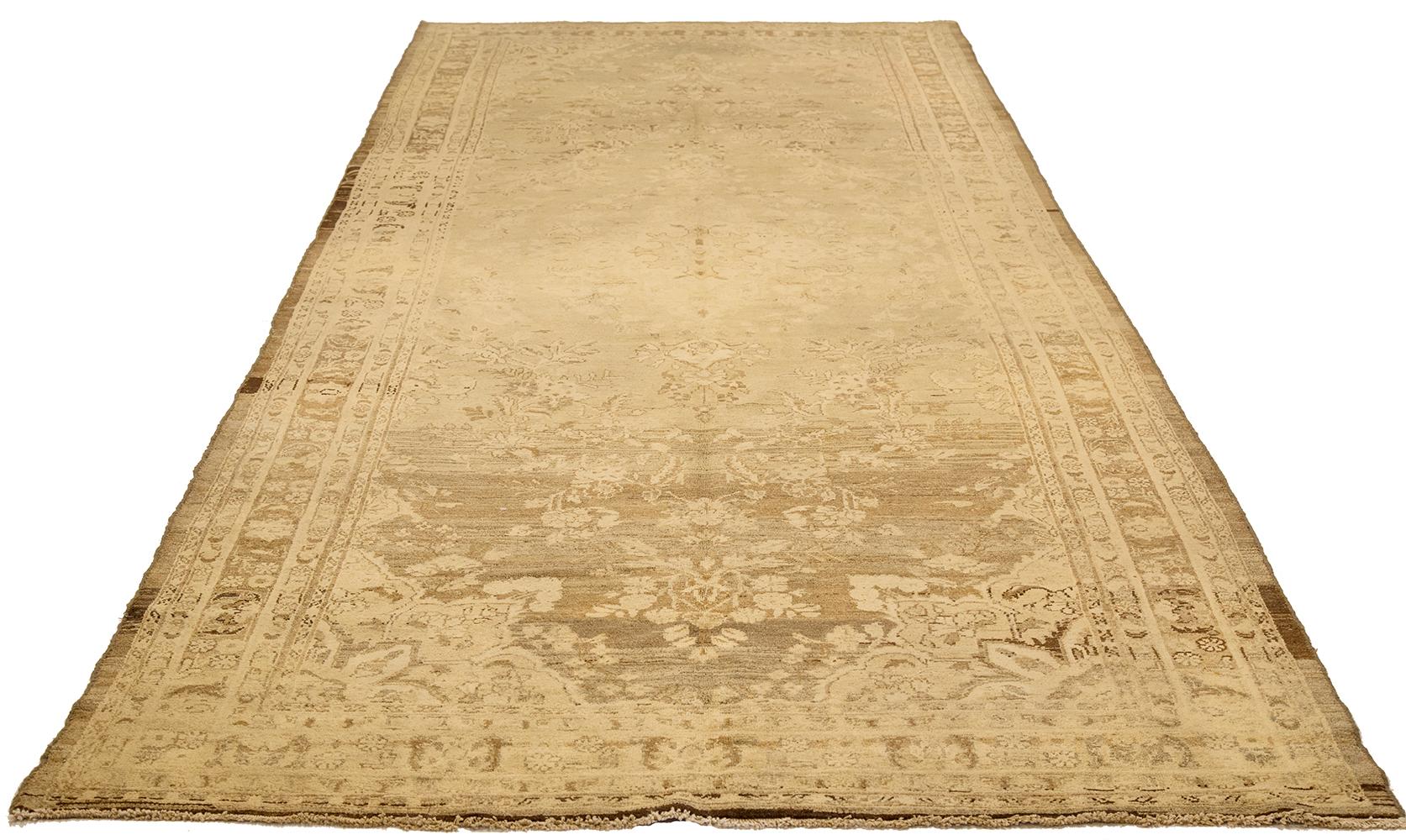 Antique Persian runner rug handwoven from the finest sheep’s wool and colored with all-natural vegetable dyes that are safe for humans and pets. It’s a traditional Malayer design featuring ivory and brown floral details over a beige field. It’s a