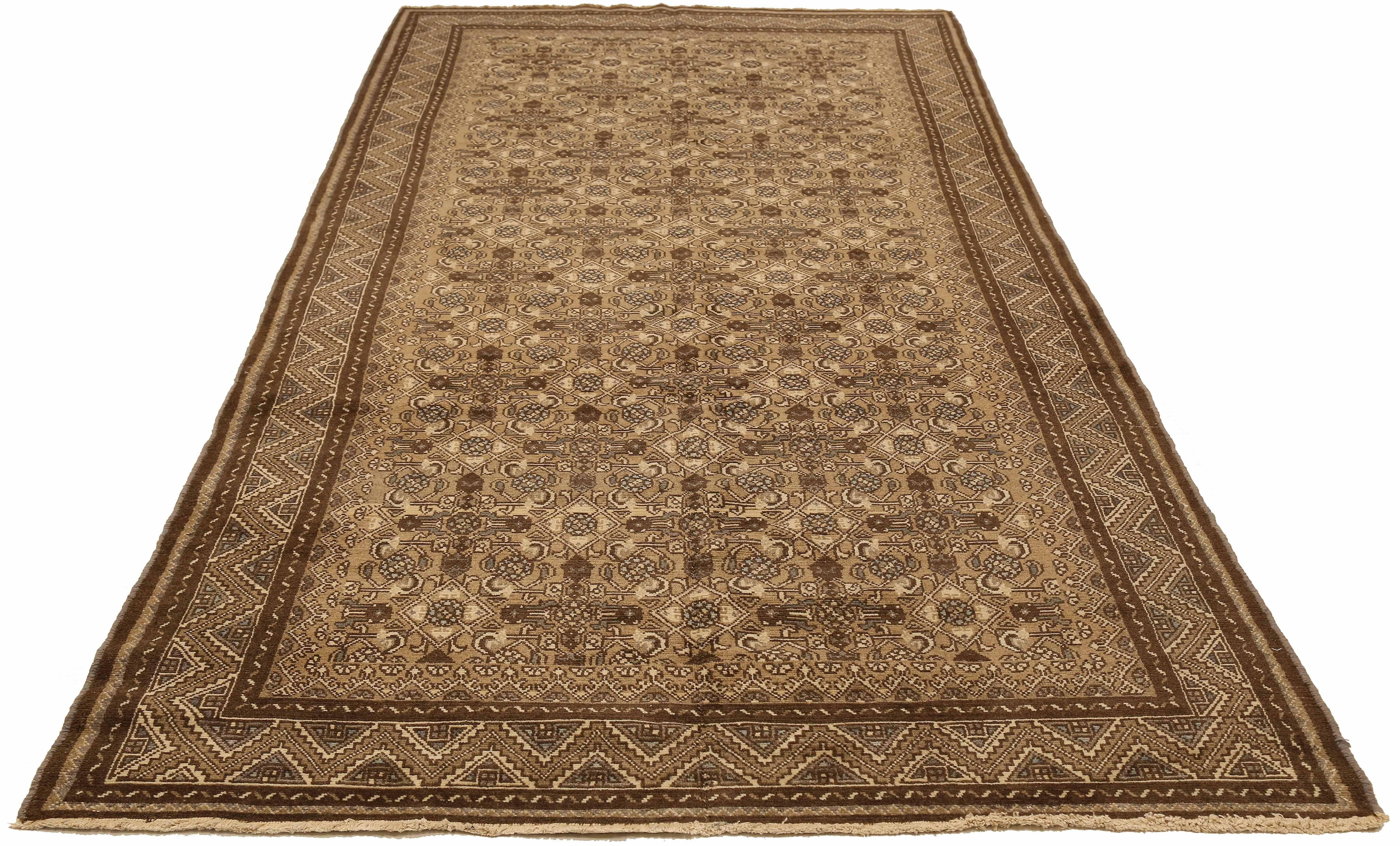 Antique Persian runner rug handwoven from the finest sheep’s wool and colored with all-natural vegetable dyes that are safe for humans and pets. It’s a traditional Malayer design featuring ivory and brown geometric details over a beige field. It’s a