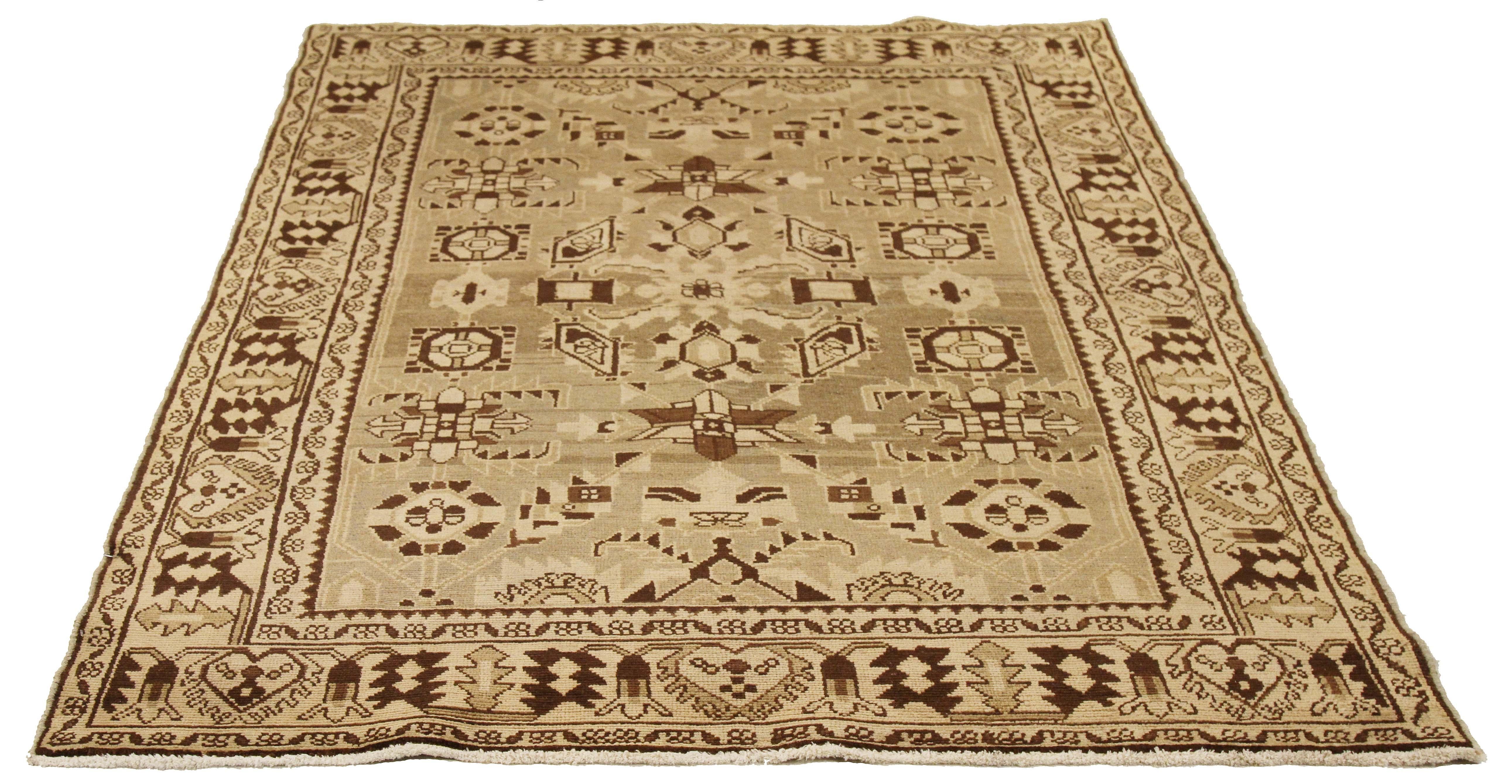 Antique Persian runner rug handwoven from the finest sheep’s wool and colored with all-natural vegetable dyes that are safe for humans and pets. It’s a traditional Malayer design featuring ivory and brown tribal details over a beige field. It’s a