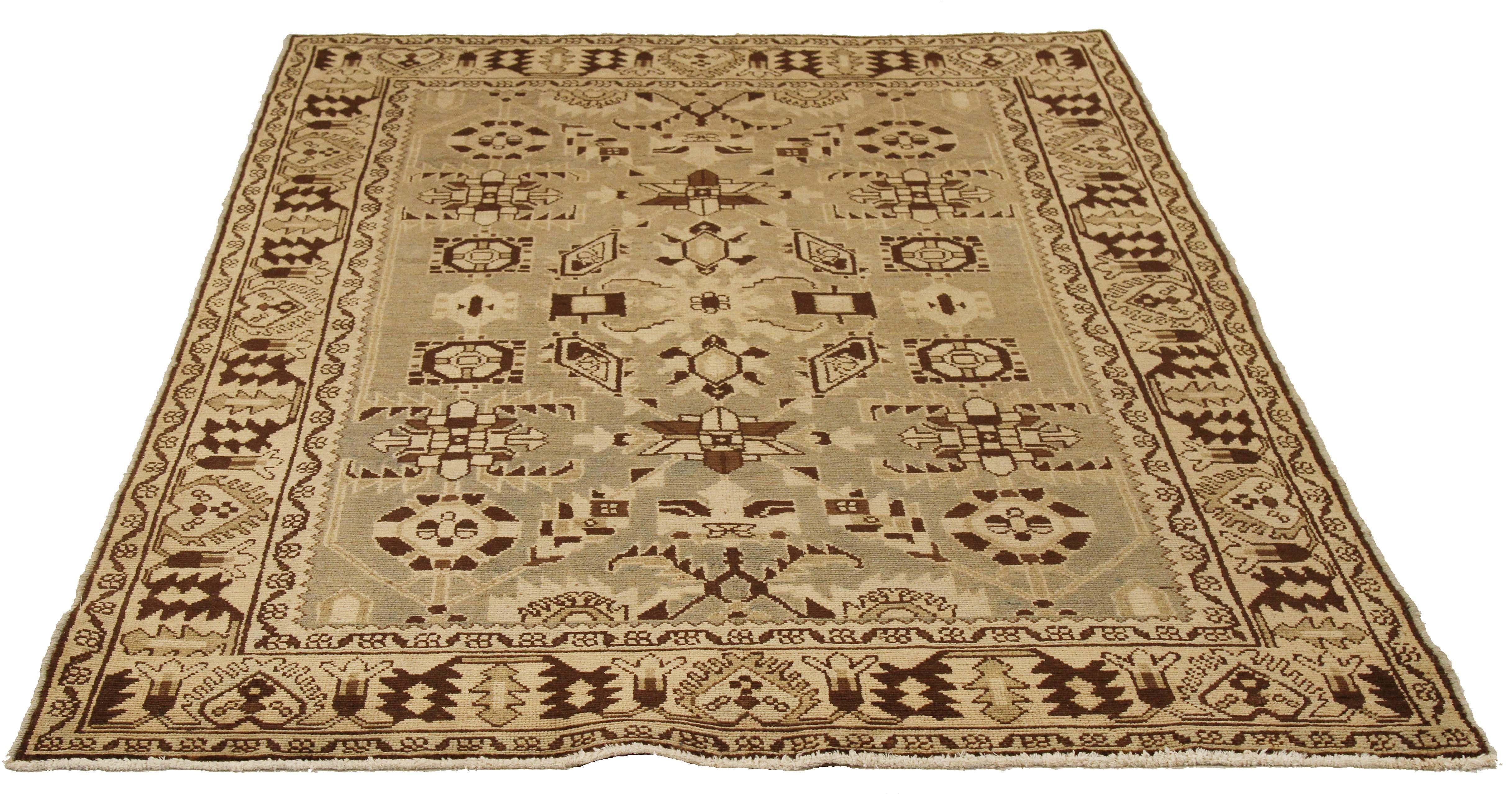 Antique Persian runner rug handwoven from the finest sheep’s wool and colored with all-natural vegetable dyes that are safe for humans and pets. It’s a traditional Malayer design featuring brown and ivory tribal details over a beige field. It’s a
