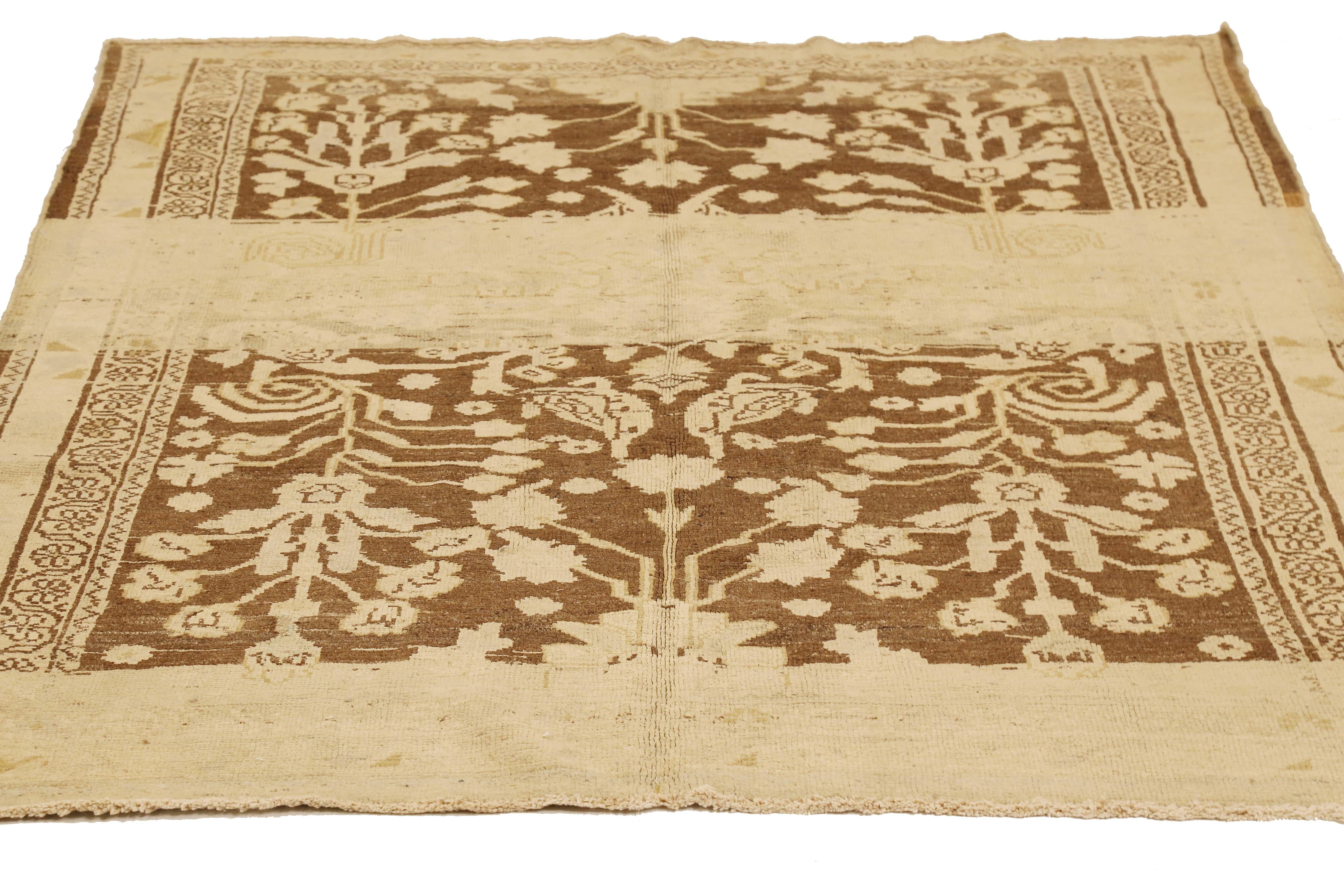 Antique Persian rug handwoven from the finest sheep’s wool and colored with all-natural vegetable dyes that are safe for humans and pets. It’s a traditional Malayer design featuring ivory floral details over a brown field. It’s a lovely piece to