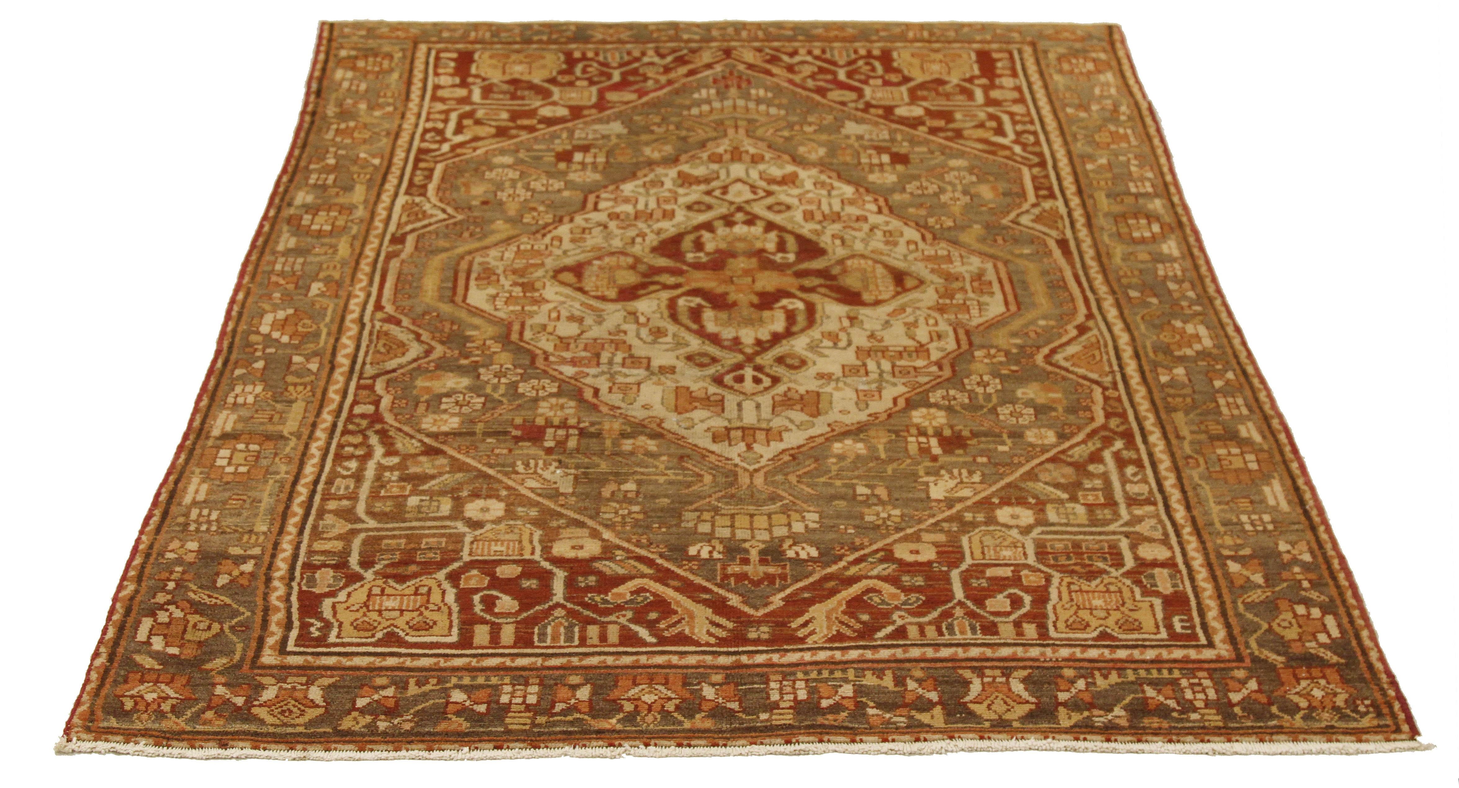 Antique Persian rug handwoven from the finest sheep’s wool and colored with all-natural vegetable dyes that are safe for humans and pets. It’s a traditional Malayer design featuring large gray and ivory central medallions over a deep red field. It’s