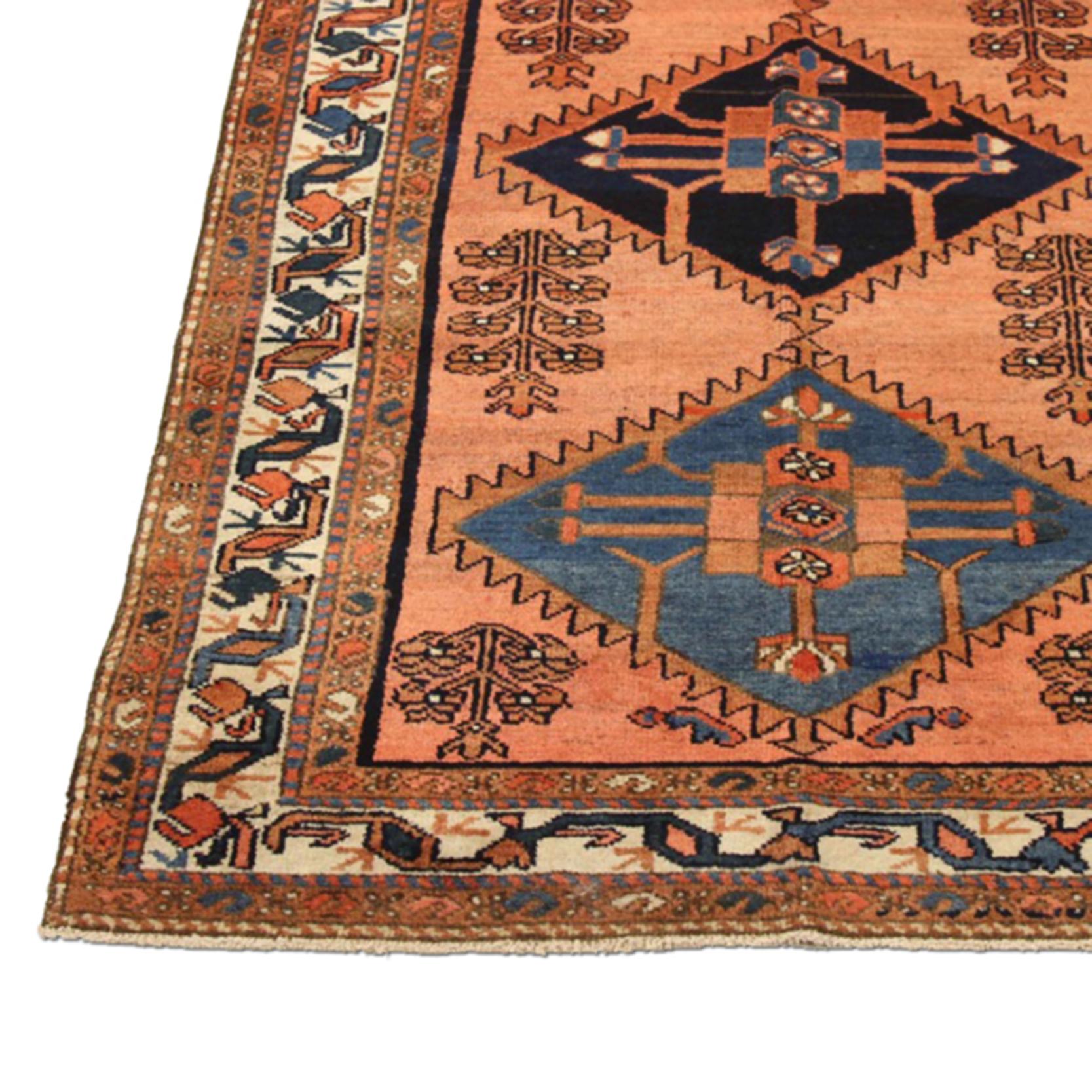 Antique Persian runner rug handwoven from the finest sheep’s wool and colored with all-natural vegetable dyes that are safe for humans and pets. It’s a traditional Malayer design featuring three large diamond central medallions over a pink center