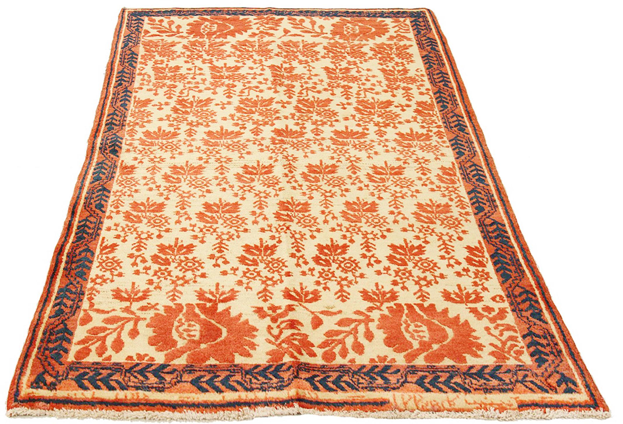 Antique Persian rug handwoven from the finest sheep’s wool and colored with all-natural vegetable dyes that are safe for humans and pets. It’s a traditional Malayer design featuring navy and orange floral details over an ivory field. It’s a lovely