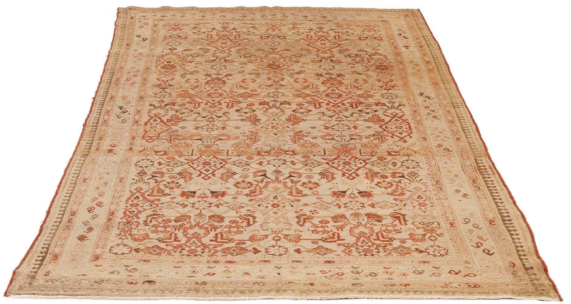 Antique Persian runner rug handwoven from the finest sheep’s wool and colored with all-natural vegetable dyes that are safe for humans and pets. It’s a traditional Malayer design featuring red and beige floral details over an ivory field. It’s a