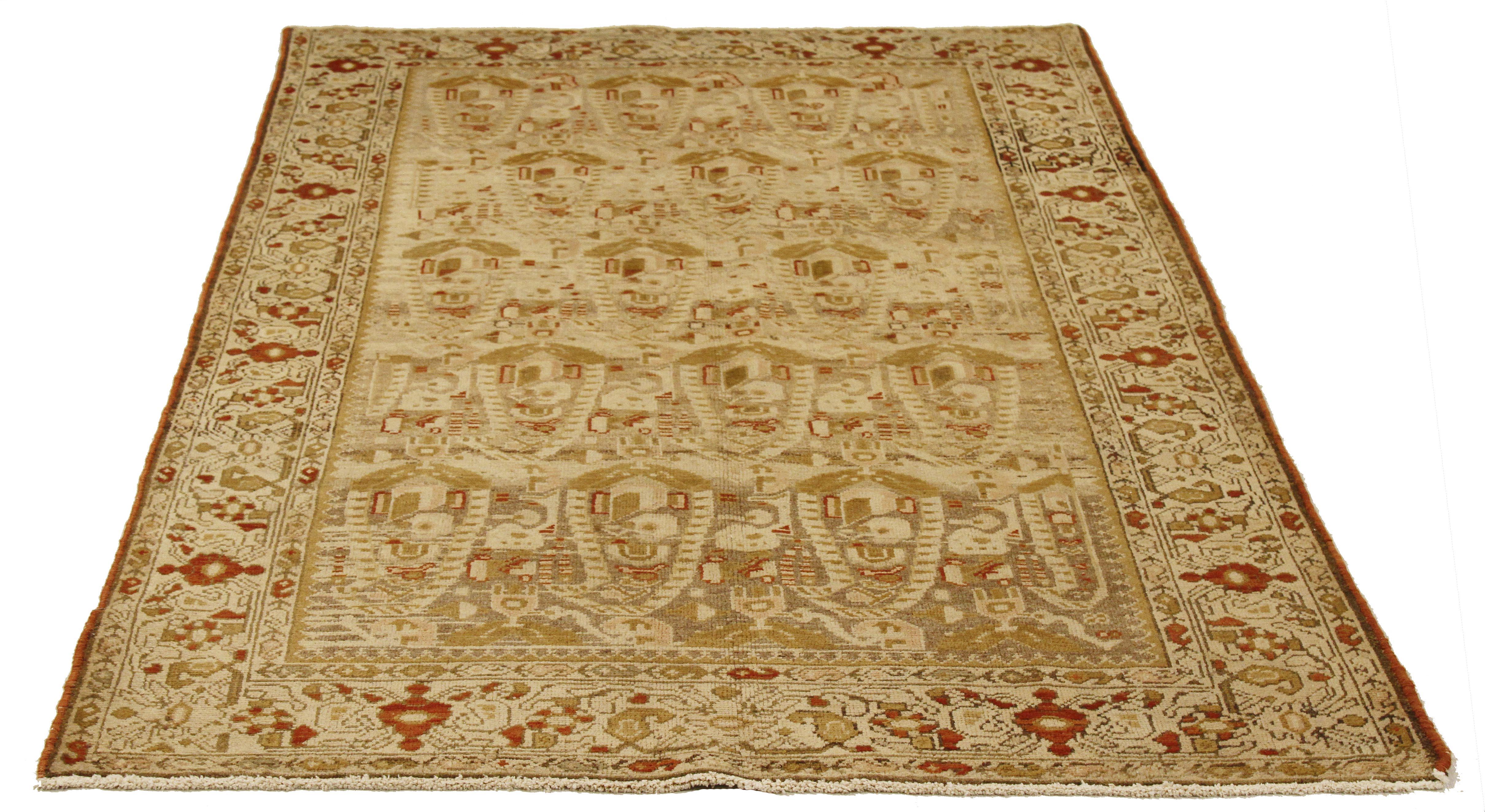 Antique Persian rug handwoven from the finest sheep’s wool and colored with all-natural vegetable dyes that are safe for humans and pets. It’s a traditional Malayer design featuring green and red botanical details all-over an ivory field. It’s a