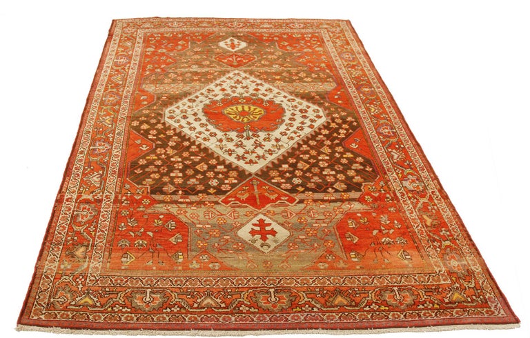 Antique Persian rug handwoven from the finest sheep’s wool and colored with all-natural vegetable dyes that are safe for humans and pets. It’s a traditional Malayer design featuring red and white floral details. It’s a lovely piece to showcase in