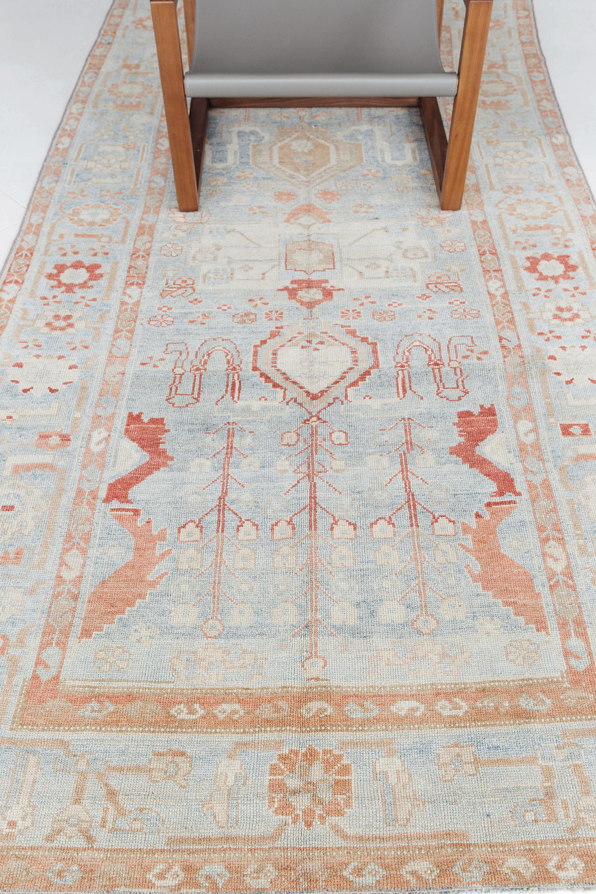This rug features two prominent, albeit soft, colors: turquoise and red. The designs in red are gorgeous floral and vine patterns, set against the turquoise background. A nice border with more floral patterns in red adds elegance to this Persian