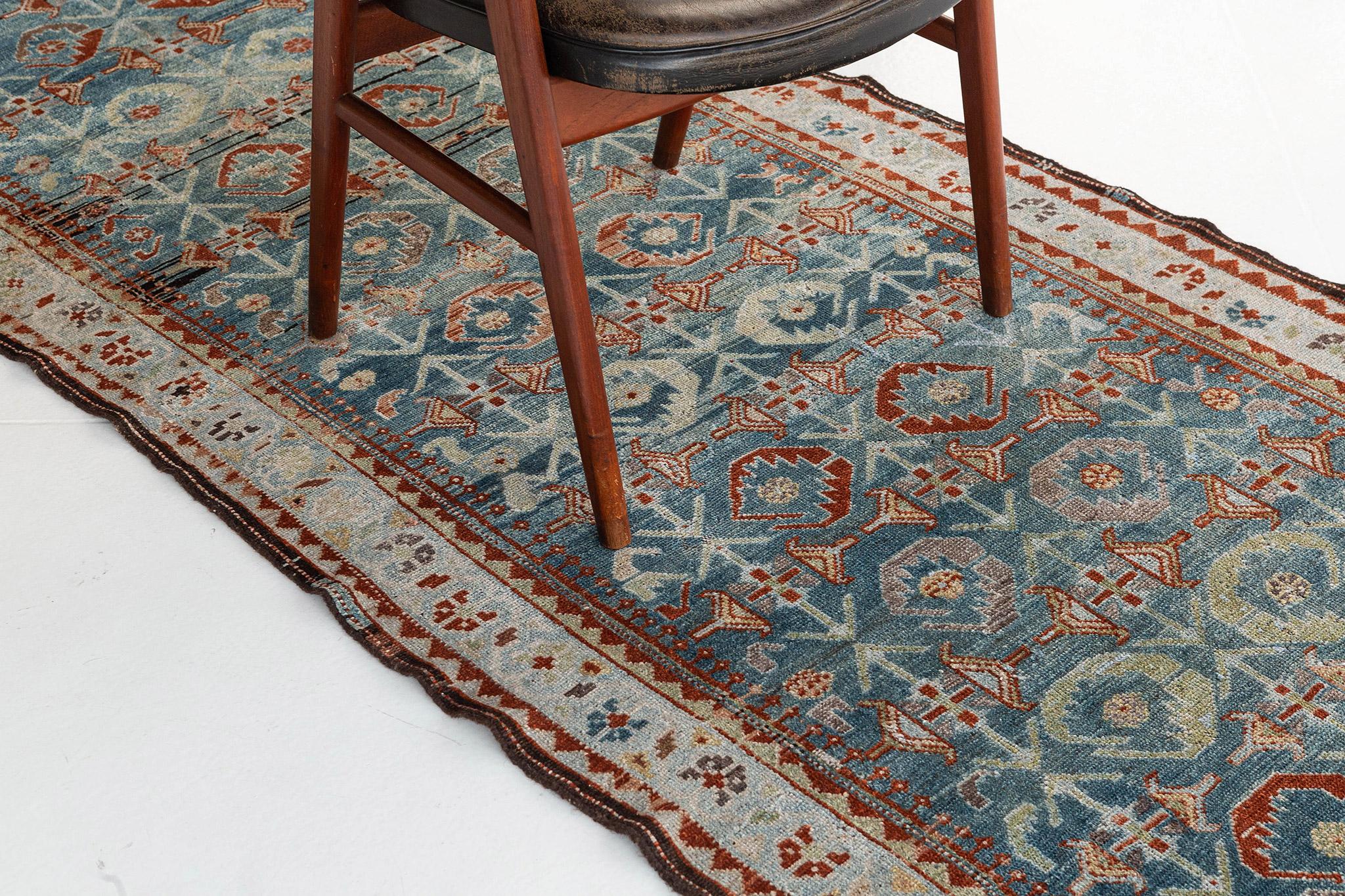 This Persian Malayer Runner is a true beauty with its arraying, eye-catching colors and design. The center is highlighted with a beautiful ocean blue, encapsulated in a large hexagon that goes almost from end to end on the carpet. Border the