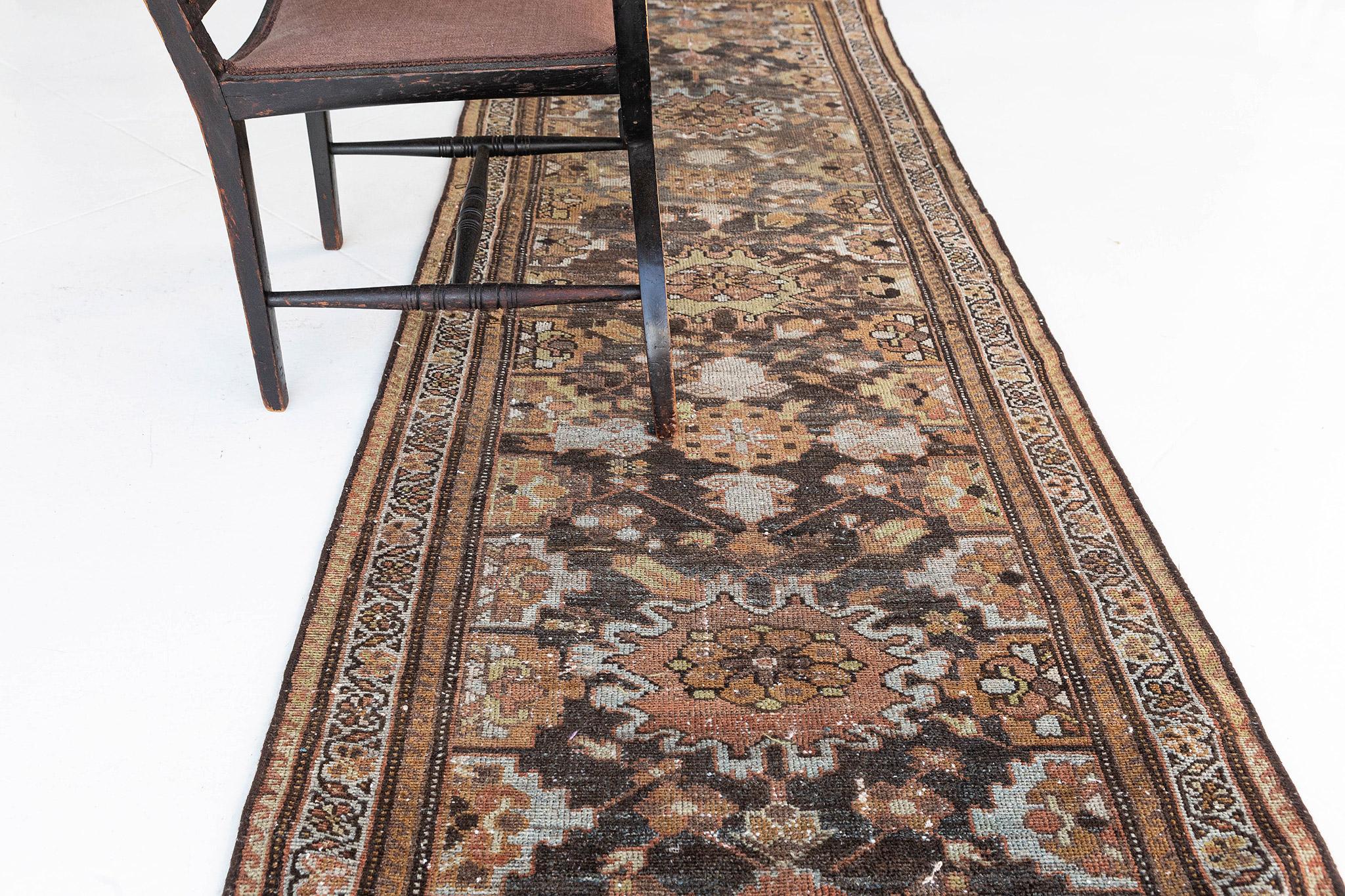 This elegant and timeless Persian Malayer rug made from vegetable dye has an intricate pattern but has clear mirrored patterns all over the design. A neutral color palette of palmettes and diamonds is perfectly toned with velvet gold accents. If you