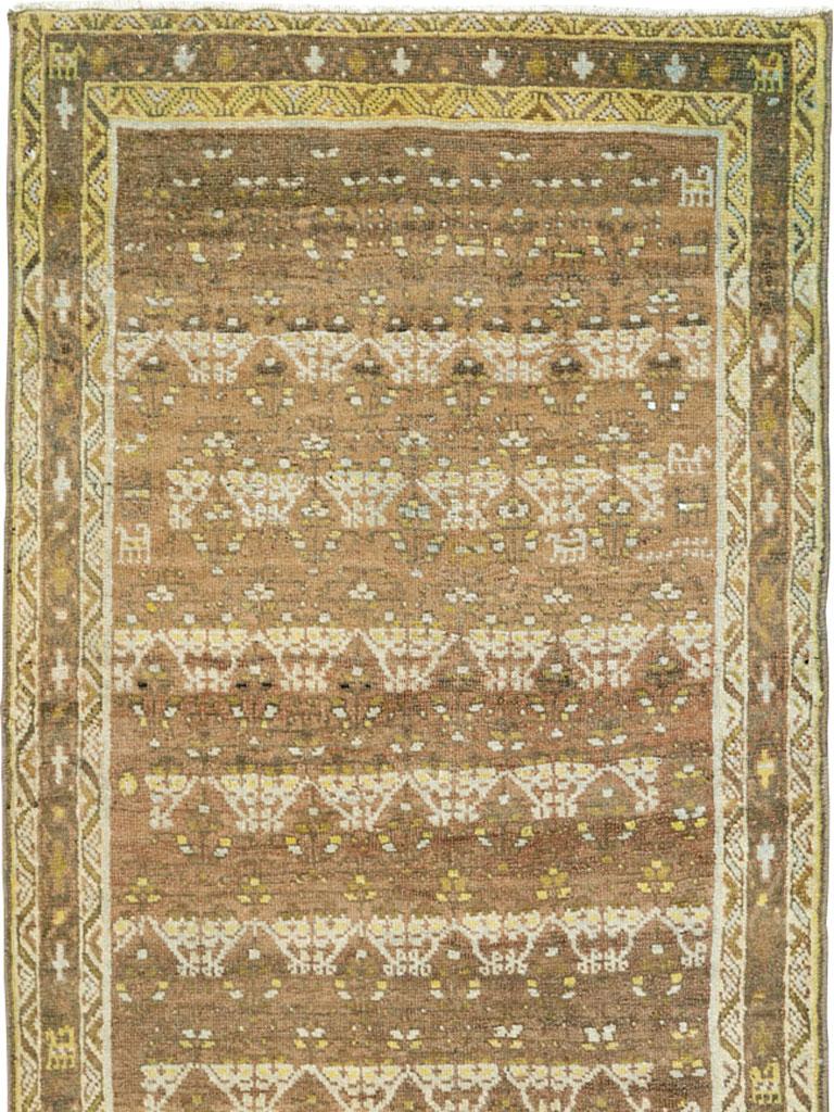 An antique Persian Malayer rug in runner format from the early 20th century.