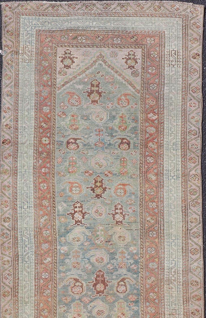 This antique Persian Malayer rug features a sub-geometric design rendered in soft colored tones. A complementary, multi-tiered border encompasses the entirety of the piece; making it a marvelous fit for a wide variety of interiors.

Antique
