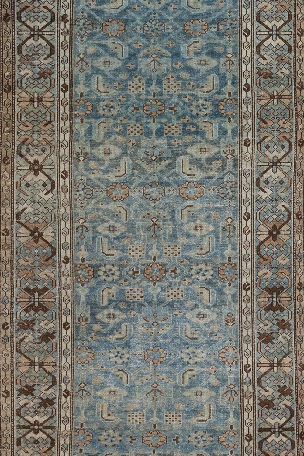 Age: Circa 1920

Colors: blue, brown, charcoal, green

Pile: medium-low

Material: Wool on cotton

Wear Notes: 2 

Wear Guide:

Vintage and antique rugs are by nature, pre-loved and may show evidence of their past. There are varying