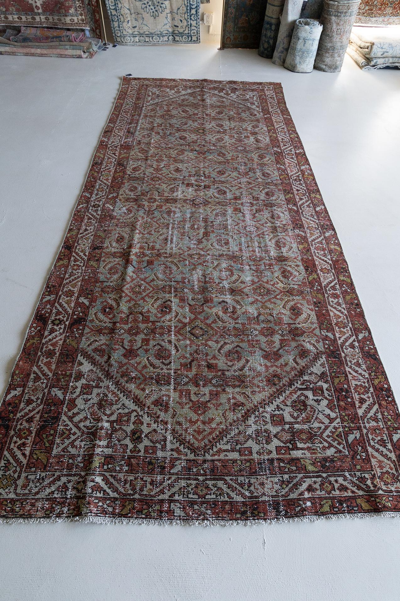 Age: Circa 1920

Colors: Persian Plum, Black and Spice on a blue field. 

Pile: low.

Material: Wool on Cotton.

Wear Notes: 3

Wear Guide:
Vintage and antique rugs are by nature, pre-loved and may show evidence of their past. There are