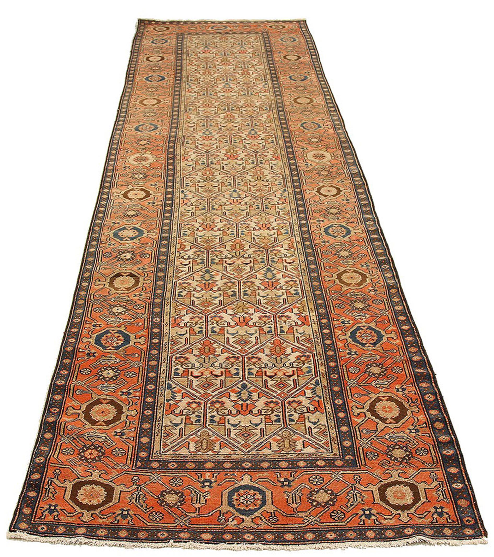Antique Persian rug handwoven from the finest sheep’s wool and colored with all-natural vegetable dyes that are safe for humans and pets. It’s a traditional Malayer design featuring blue, orange and beige flower details over an ivory field. It’s a