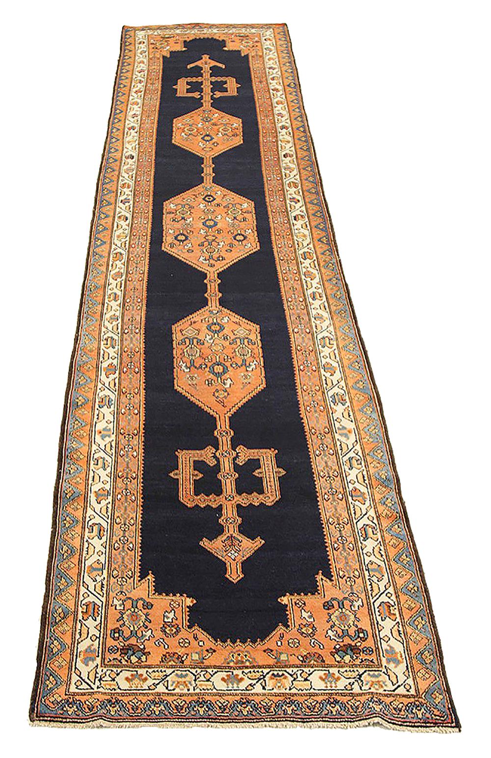Antique Persian runner rug handwoven from the finest sheep’s wool and colored with all-natural vegetable dyes that are safe for humans and pets. It’s a traditional Malayer design featuring a beautiful combination of geometric details in blue and