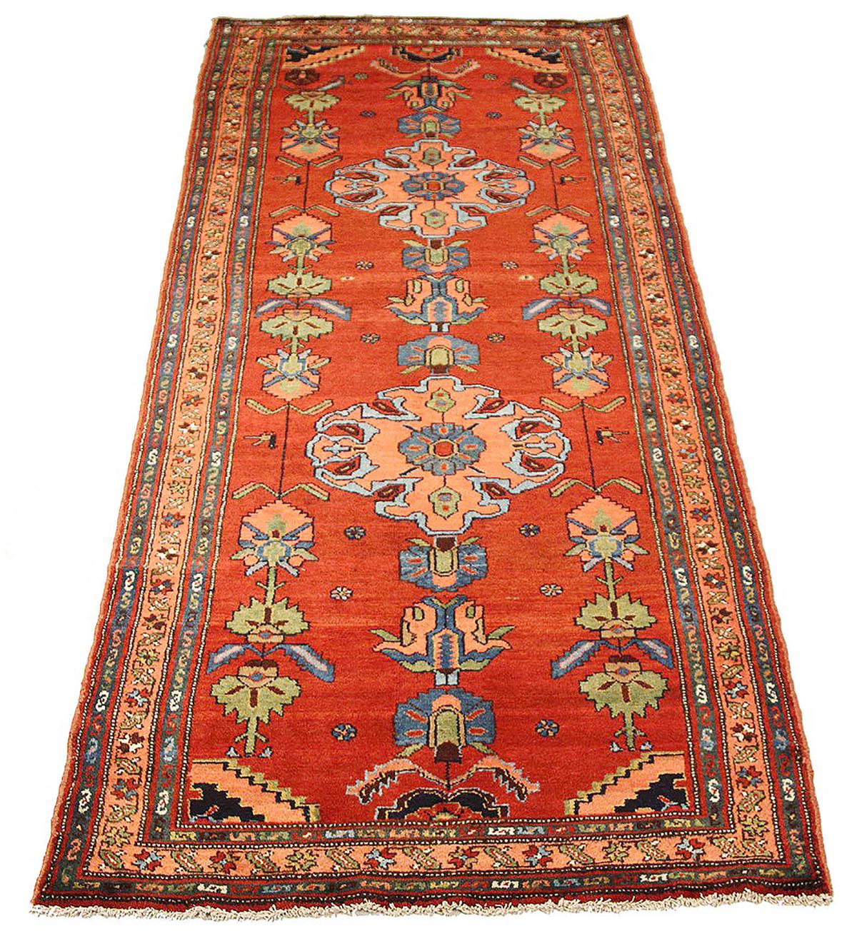Antique Persian runner rug handwoven from the finest sheep’s wool and colored with all-natural vegetable dyes that are safe for humans and pets. It’s a traditional Malayer design featuring a mixed pink, blue, and green combination of floral details