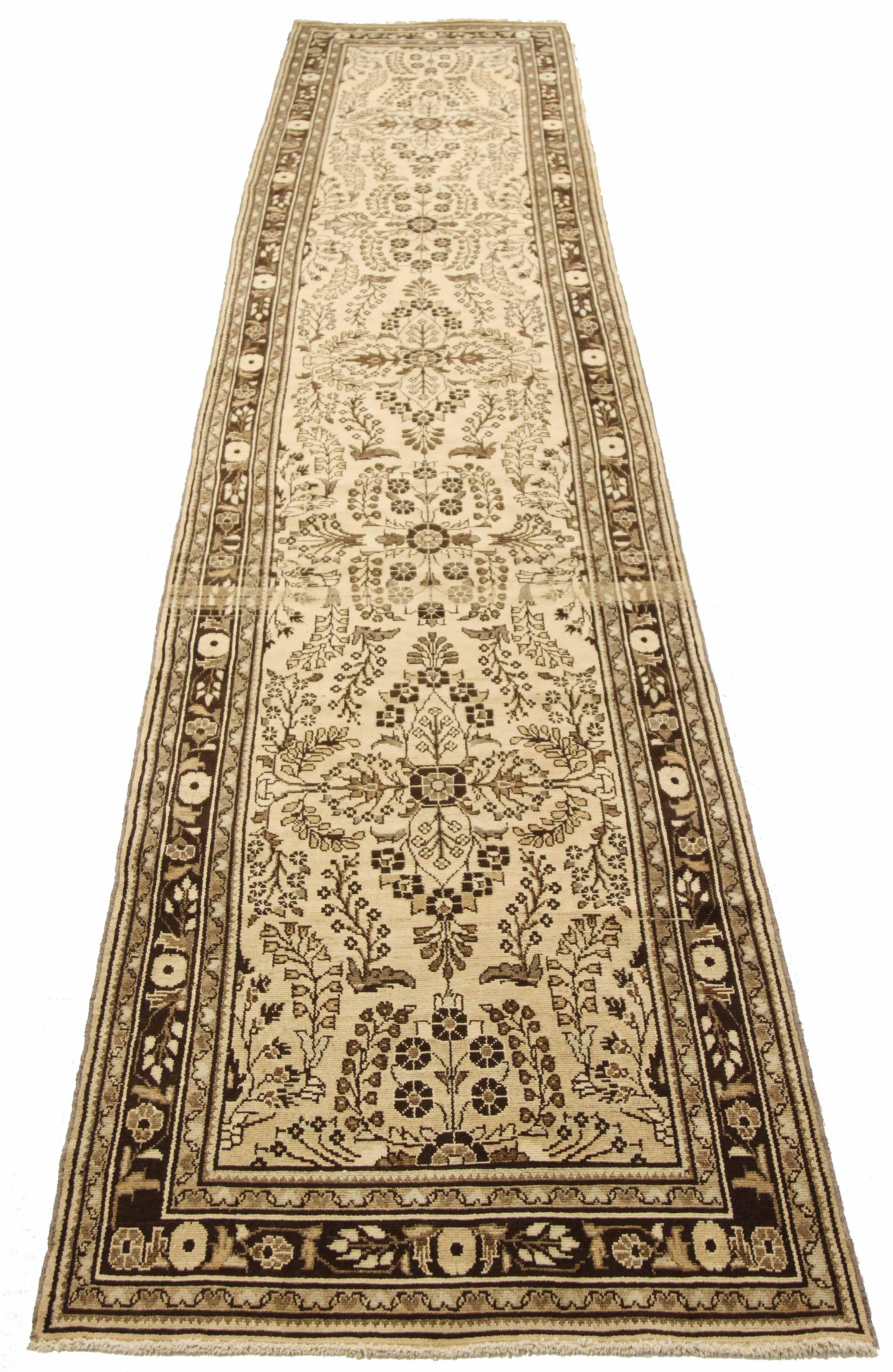 Antique Persian runner rug handwoven from the finest sheep’s wool and colored with all-natural vegetable dyes that are safe for humans and pets. It’s a traditional Malayer design featuring brown botanical details over an ivory field. It’s a lovely