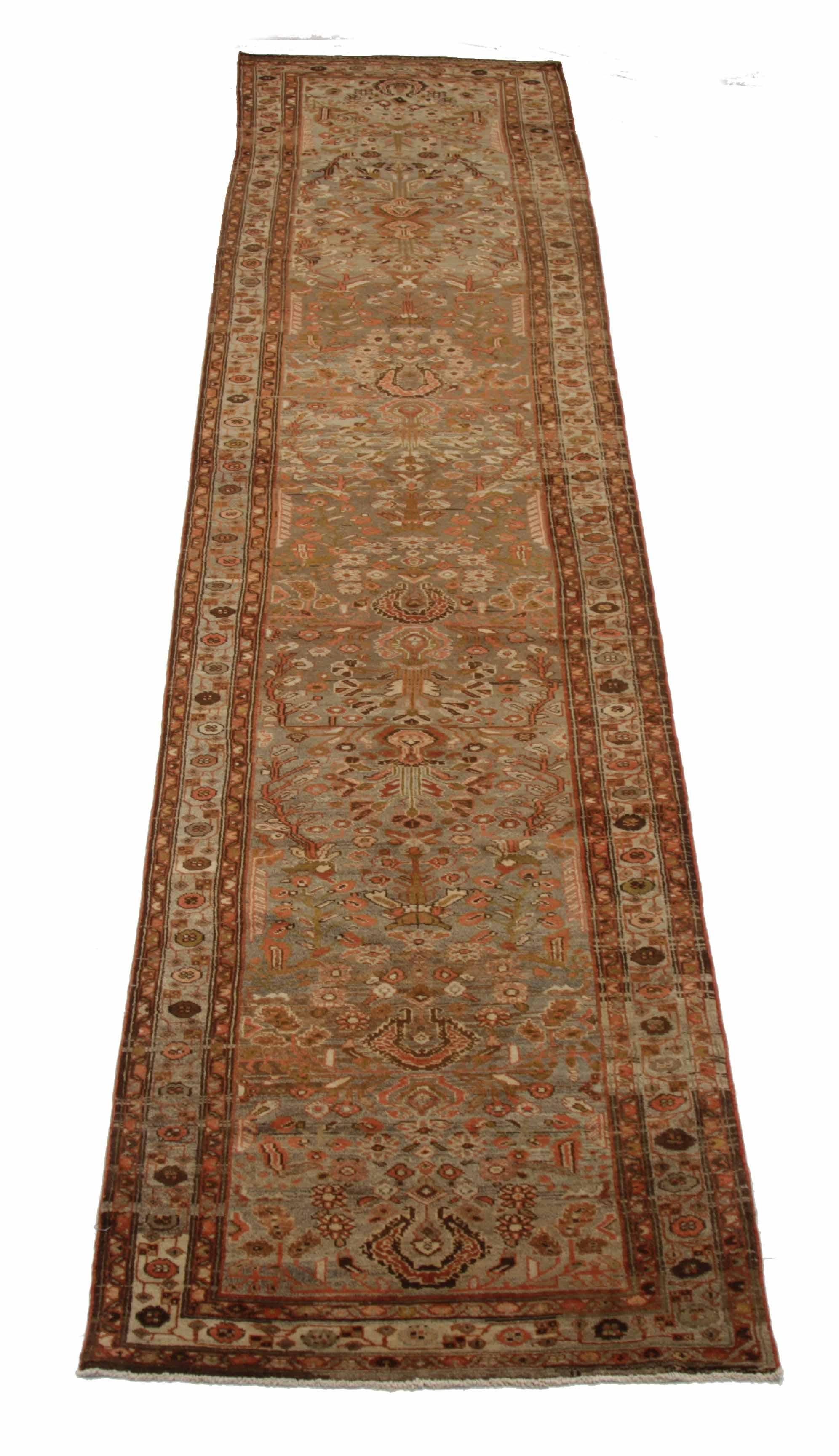 Antique Persian runner rug handwoven from the finest sheep’s wool. It’s colored with all-natural vegetable dyes that are safe for humans and pets. It’s a traditional Malayer design featuring botanical details on an ivory field. It’s a lovely piece