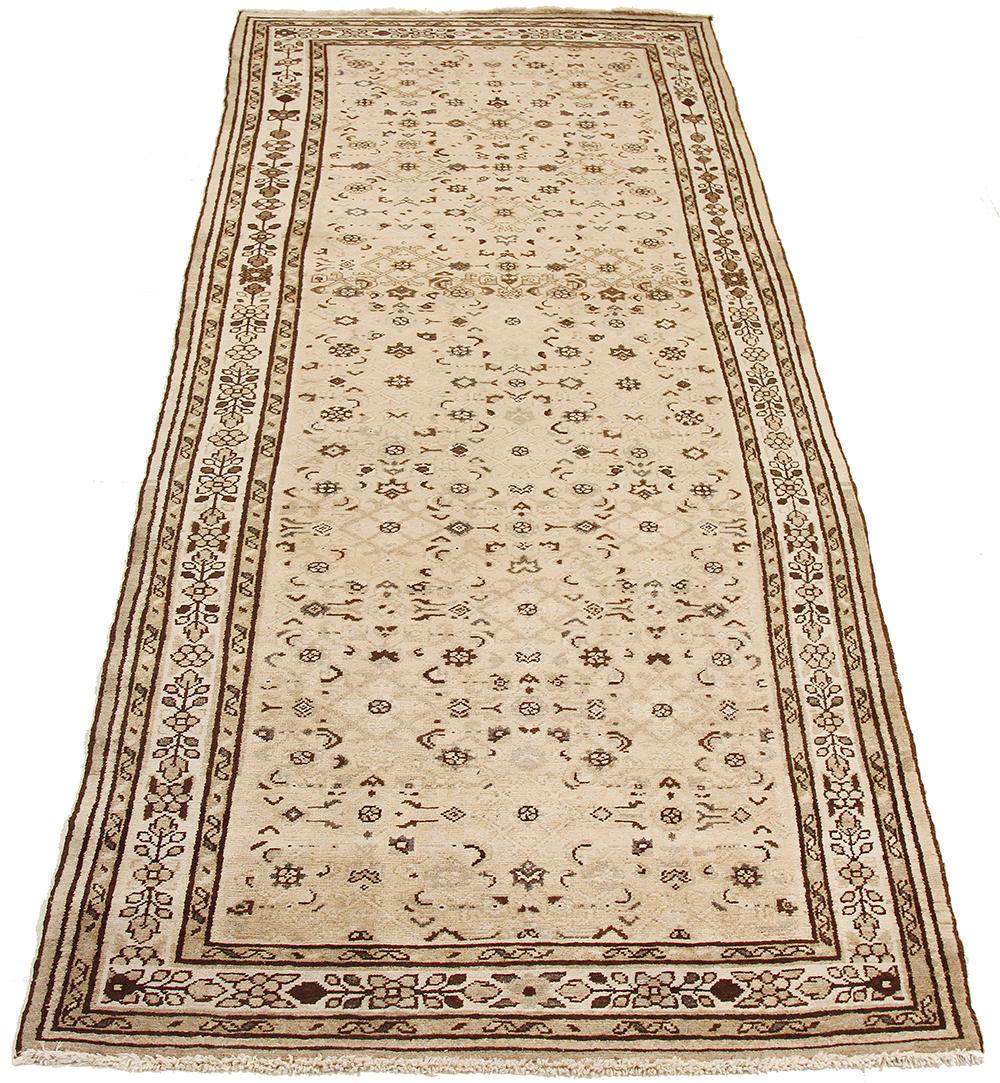 Antique Persian rug handwoven from the finest sheep’s wool and colored with all-natural vegetable dyes that are safe for humans and pets. It’s a traditional Malayer design featuring a colorful mix of floral details on an ivory field. It’s a lovely