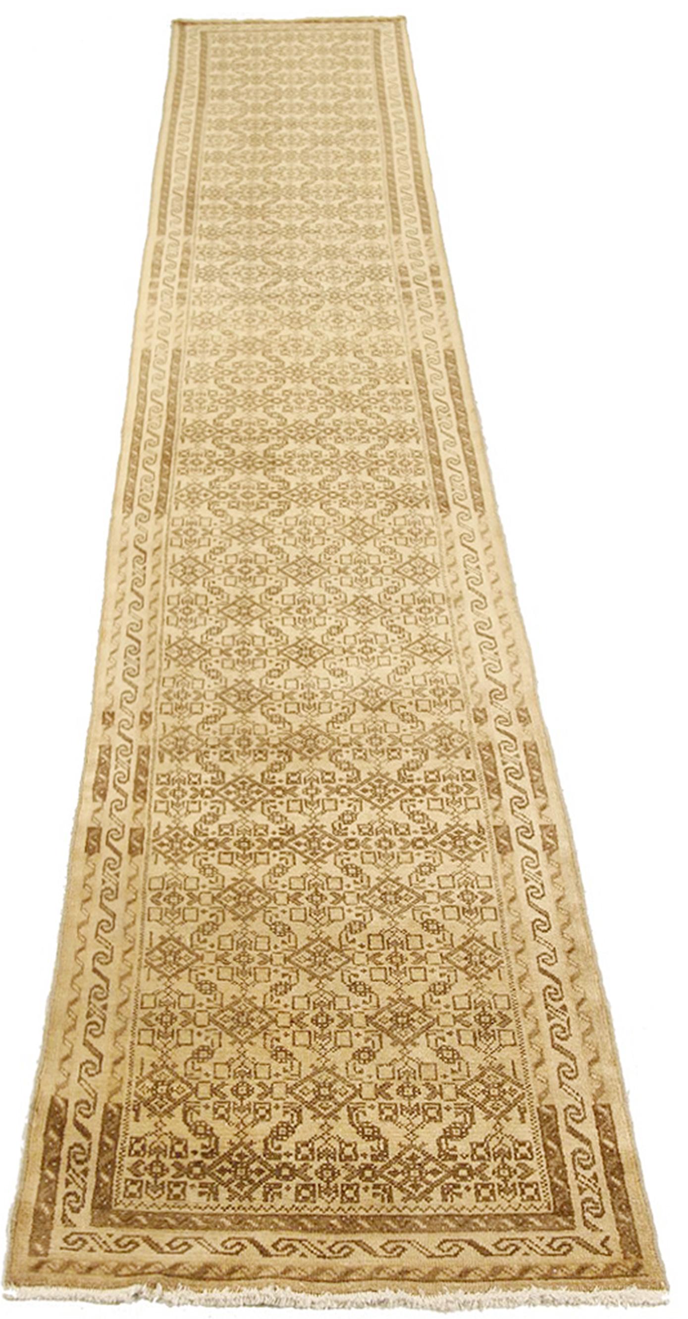 Antique Persian rug handwoven from the finest sheep’s wool and colored with all-natural vegetable dyes that are safe for humans and pets. It’s a traditional Malayer design featuring brown geometric details over a beige field. It’s a lovely piece to