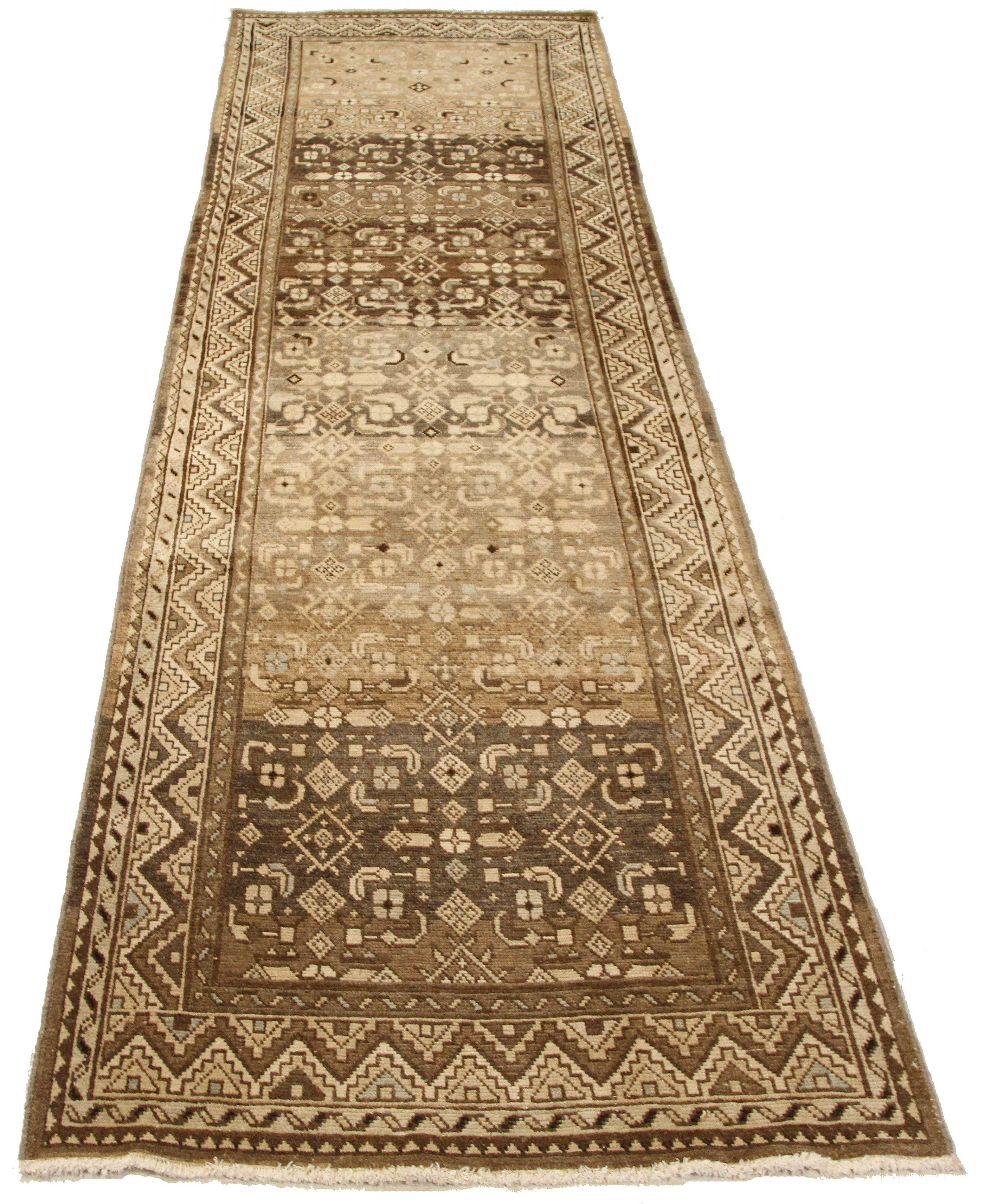 Antique Persian runner rug handwoven from the finest sheep’s wool and colored with all-natural vegetable dyes that are safe for humans and pets. It’s a traditional Malayer design featuring gray and brown geometric patterns over an ivory field. It’s