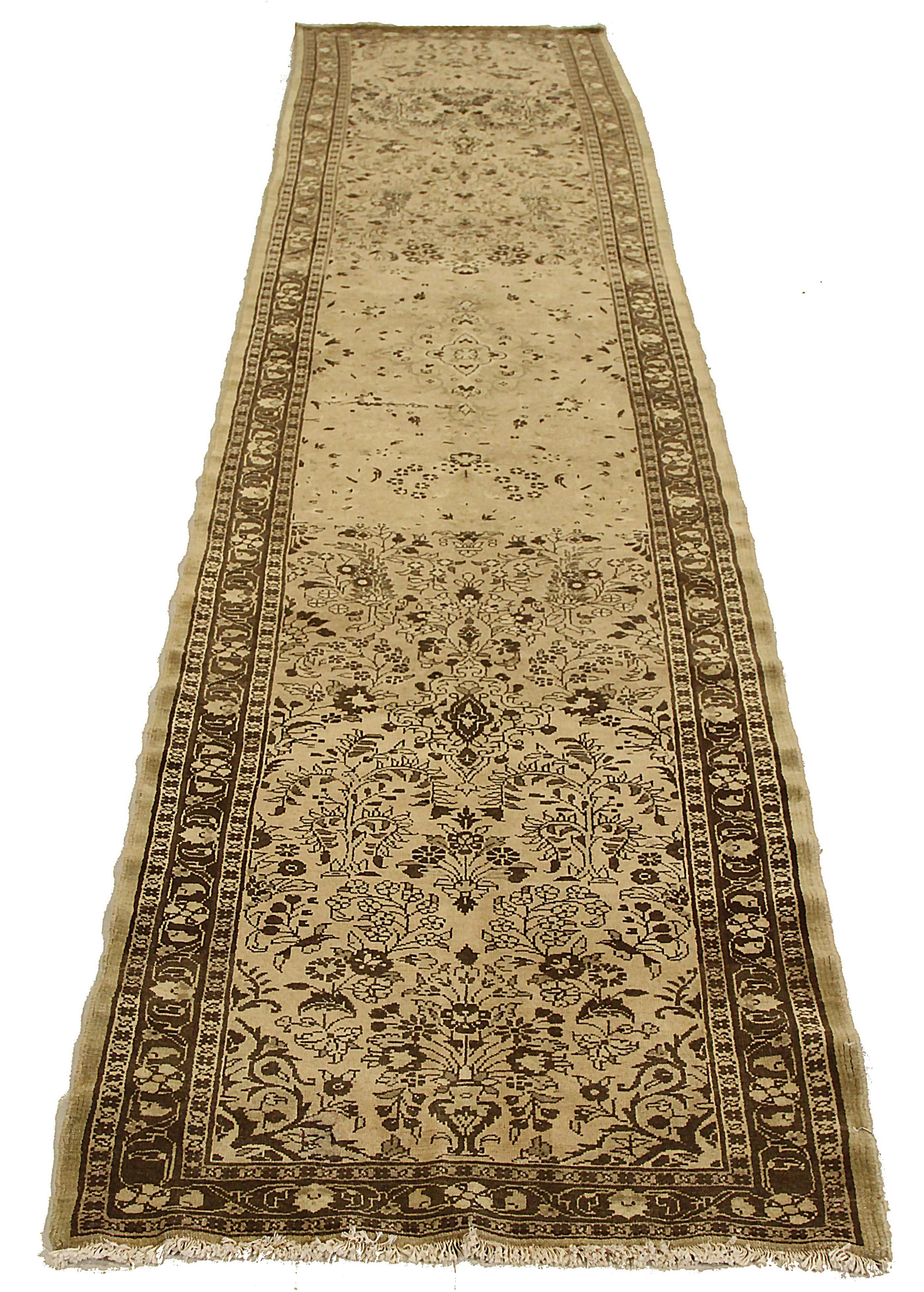 Antique Persian runner rug handwoven from the finest sheep’s wool. It’s colored with all-natural vegetable dyes that are safe for humans and pets. It’s a traditional Malayer design featuring floral design on a brown field. It’s a lovely piece to