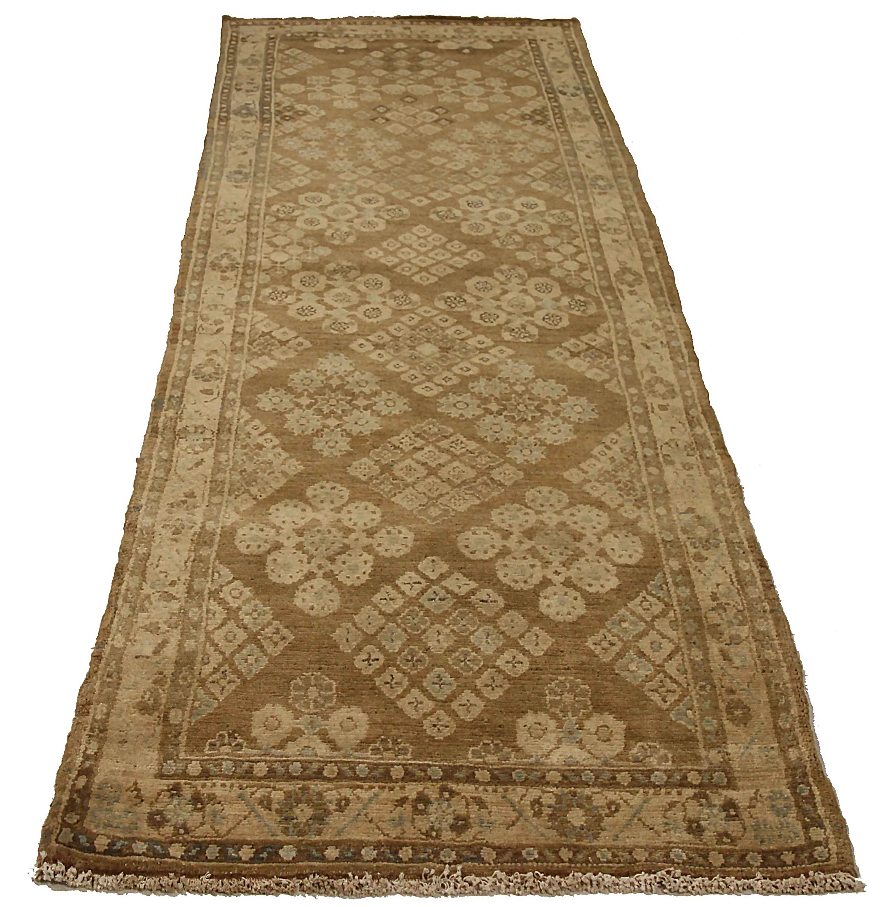 Antique Persian runner rug handwoven from the finest sheep’s wool. It’s colored with all-natural vegetable dyes that are safe for humans and pets. It’s a traditional Malayer design featuring gray and ivory floral details on a brown field. It’s a