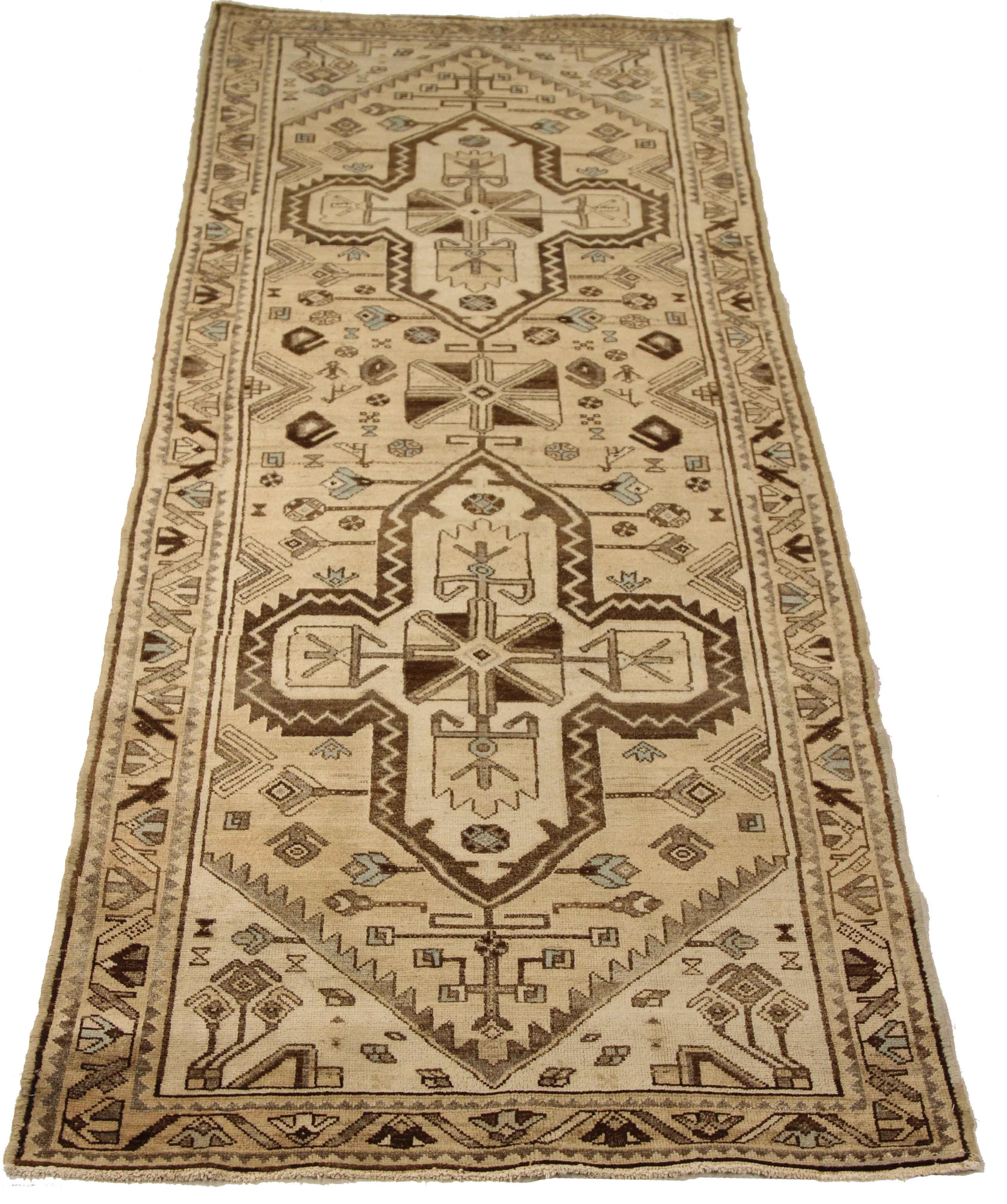 Antique Persian runner rug handwoven from the finest sheep’s wool. It’s colored with all-natural vegetable dyes that are safe for humans and pets. It’s a traditional Malayer design featuring floral details on a brown field. It’s a lovely piece to