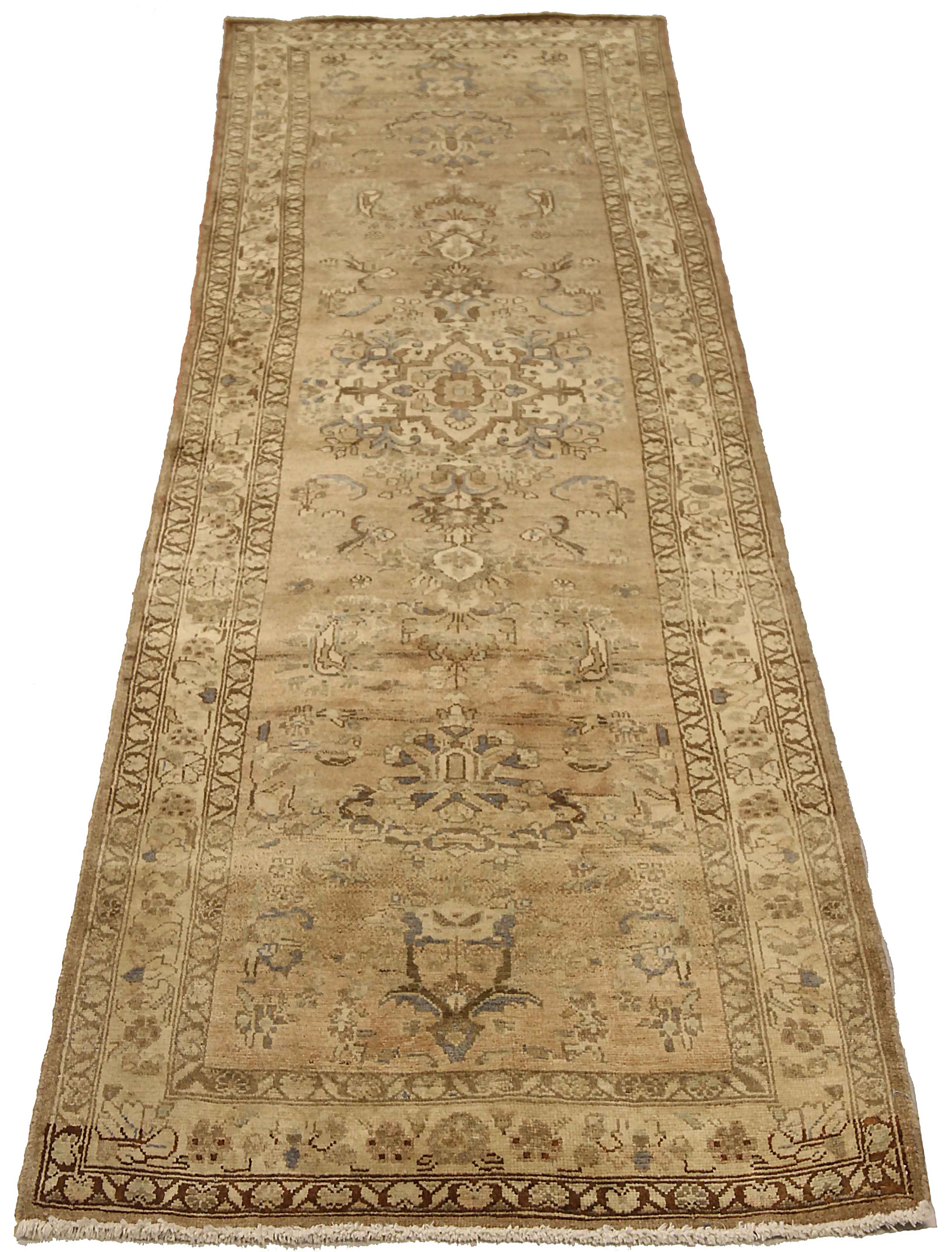 Antique Persian runner rug handwoven from the finest sheep’s wool. It’s colored with all-natural vegetable dyes that are safe for humans and pets. It’s a traditional Malayer design featuring gray and brown floral details on an ivory field. It’s a