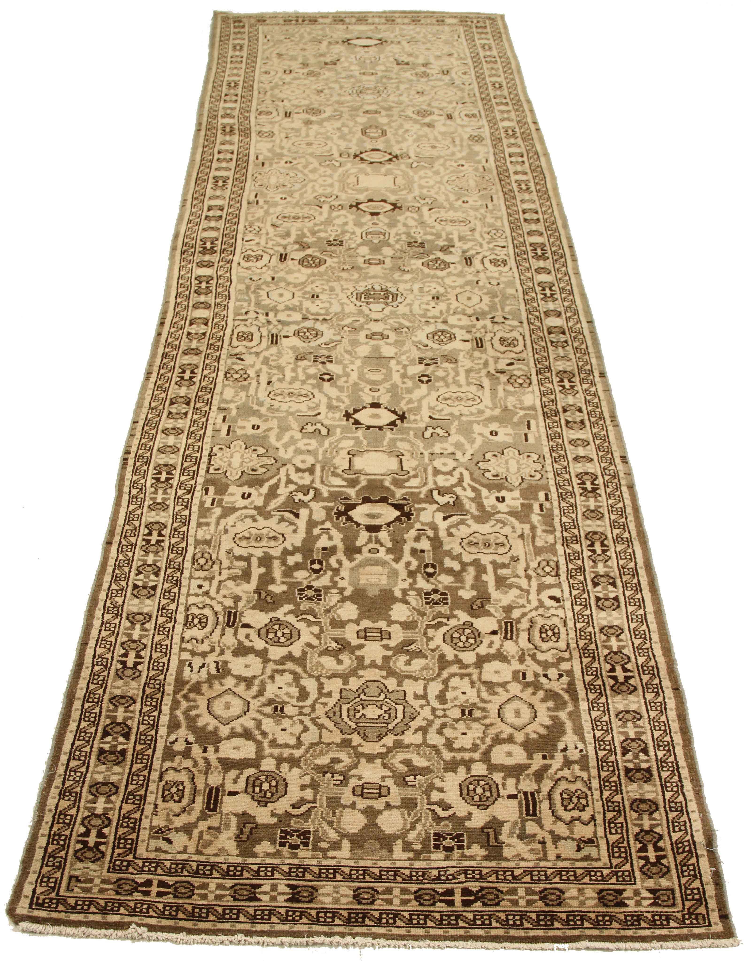 Antique Persian runner rug handwoven from the finest sheep’s wool. It’s colored with all-natural vegetable dyes that are safe for humans and pets. It’s a traditional Malayer design featuring floral details on an ivory field. It’s a lovely piece to