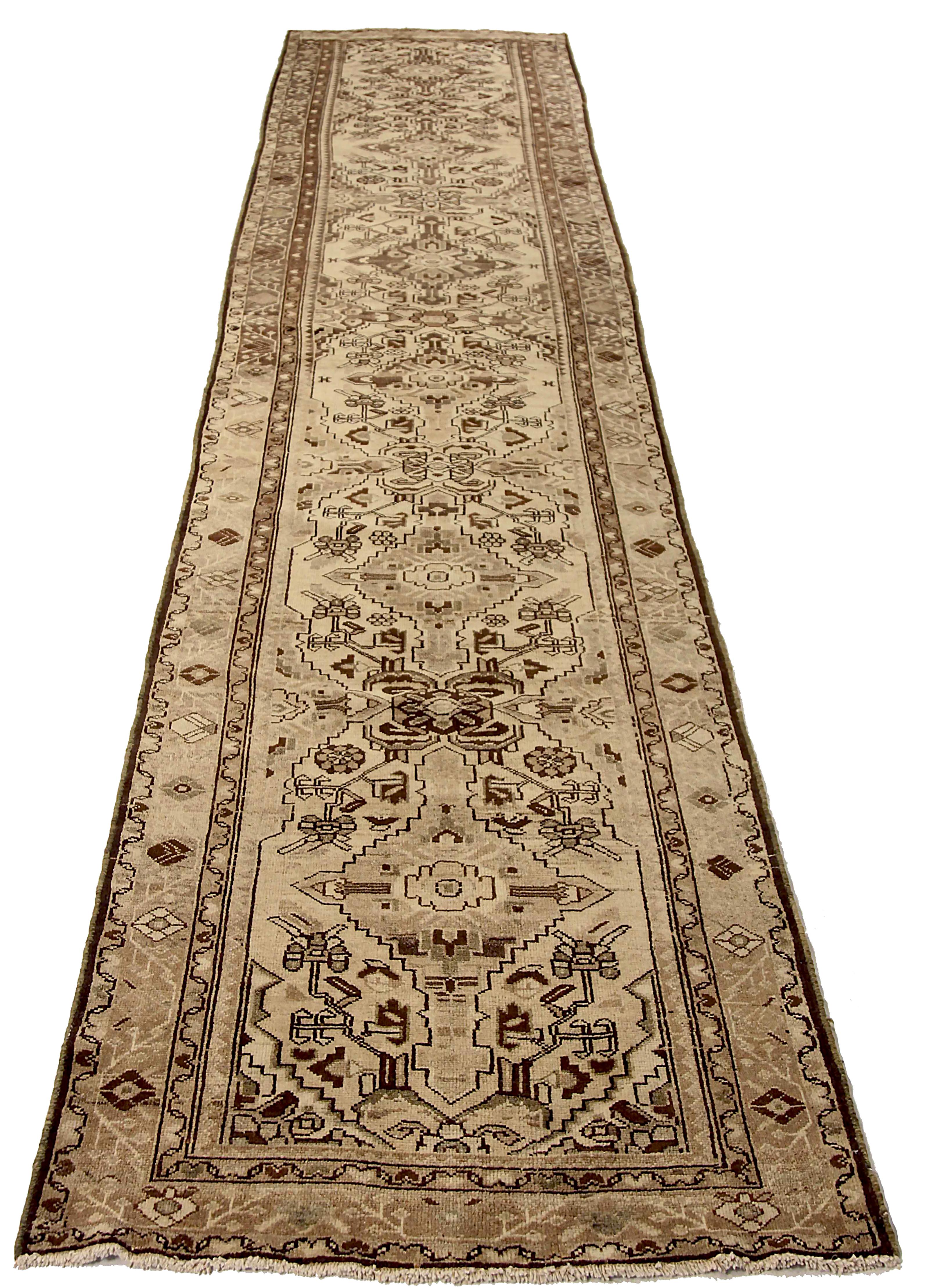 Antique Persian runner rug handwoven from the finest sheep’s wool. It’s colored with all-natural vegetable dyes that are safe for humans and pets. It’s a traditional Malayer design featuring floral details on an ivory field. It’s a lovely piece to
