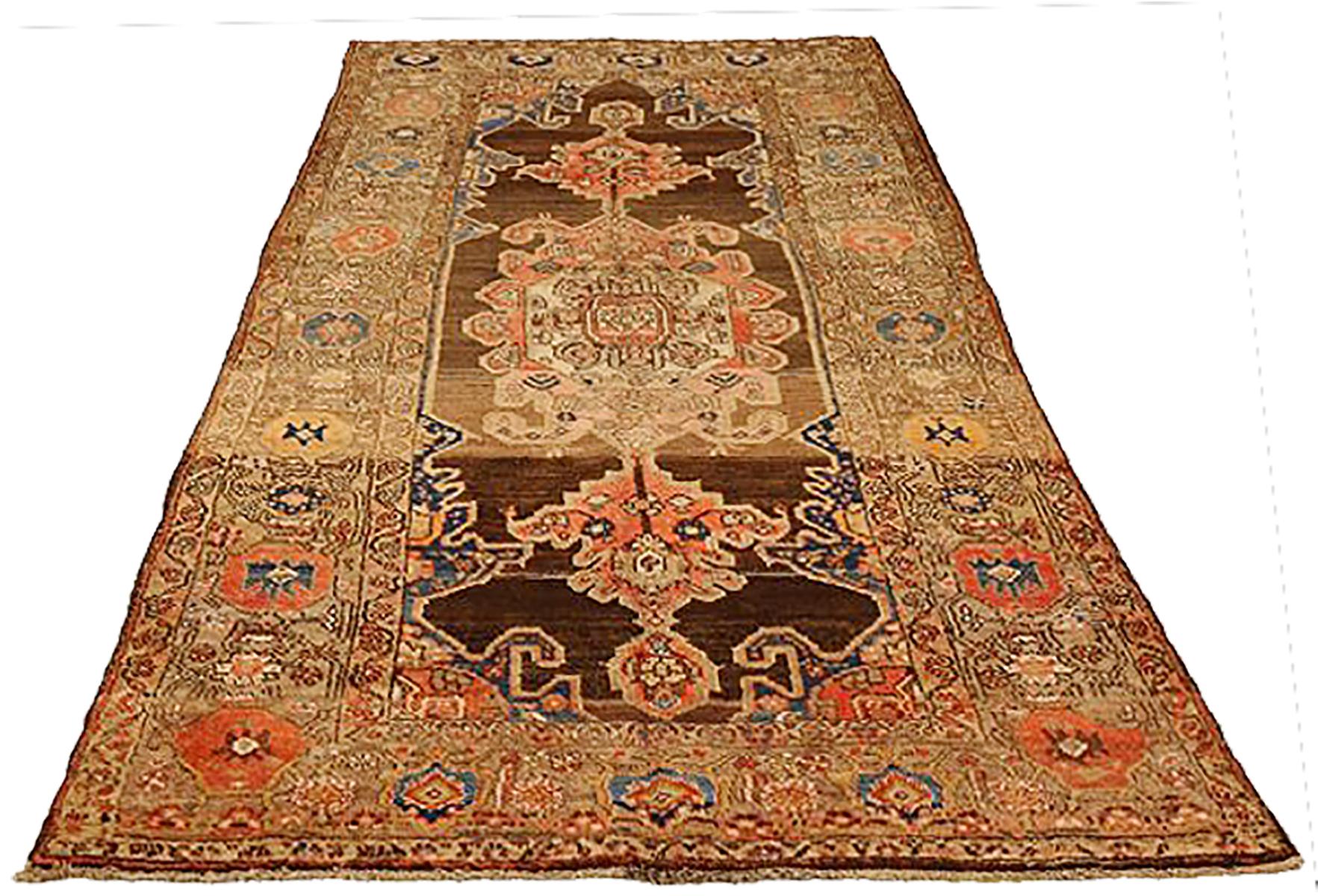 Antique Persian runner rug handwoven from the finest sheep’s wool and colored with all-natural vegetable dyes that are safe for humans and pets. It’s a traditional Malayer design featuring a mixed navy, brown and red combination of floral medallion
