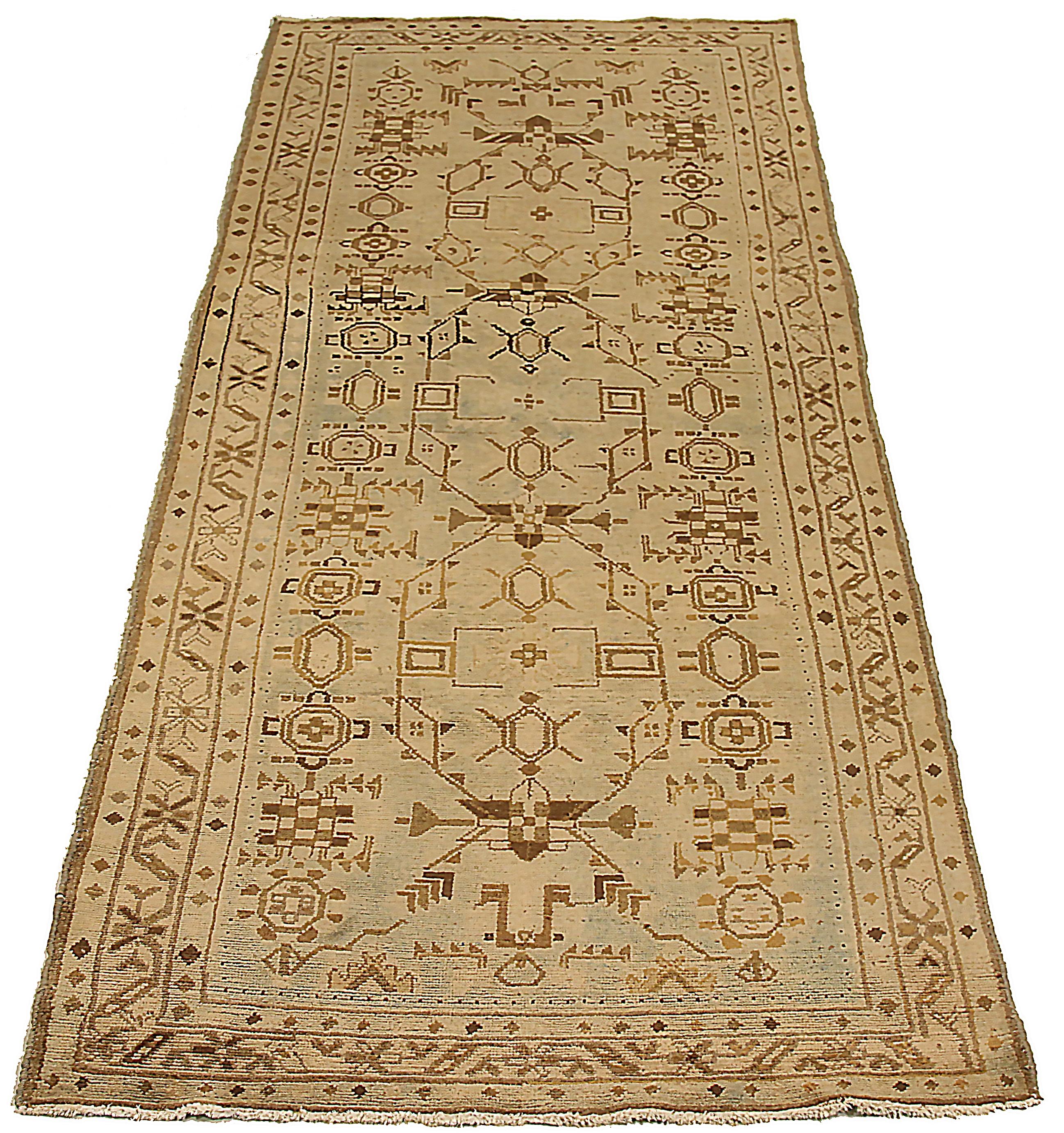 Antique Persian area rug handwoven from the finest sheep’s wool. It’s colored with all-natural vegetable dyes that are safe for humans and pets. It’s a traditional Malayer design featuring geometric design on a beige field. It’s a lovely piece to