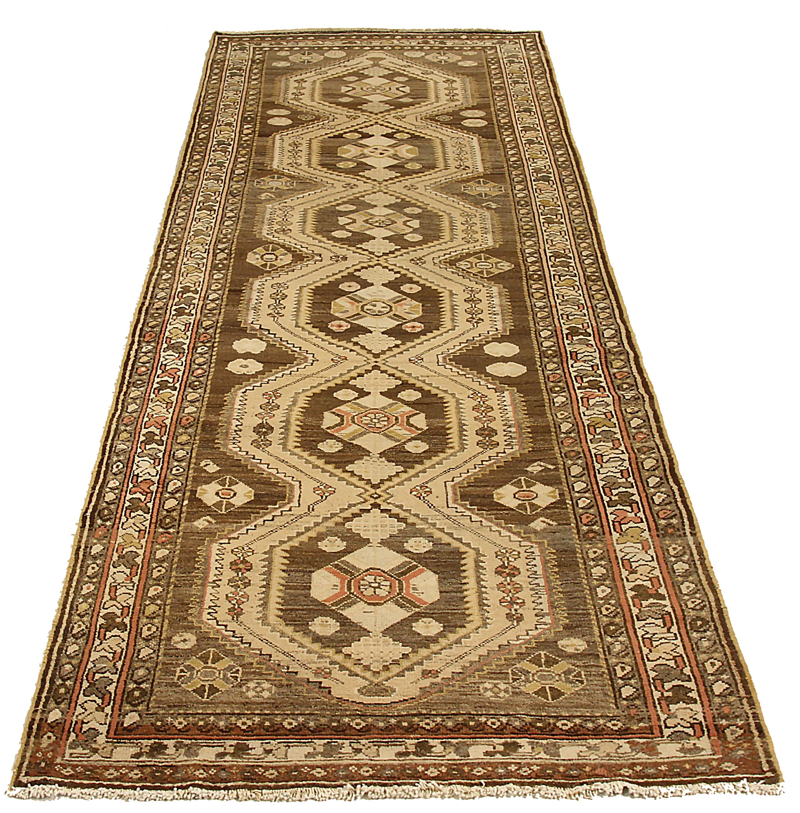 Antique Persian area rug handwoven from the finest sheep’s wool. It’s colored with all-natural vegetable dyes that are safe for humans and pets. It’s a traditional Malayer design featuring geometric design on a brown field. It’s a lovely piece to