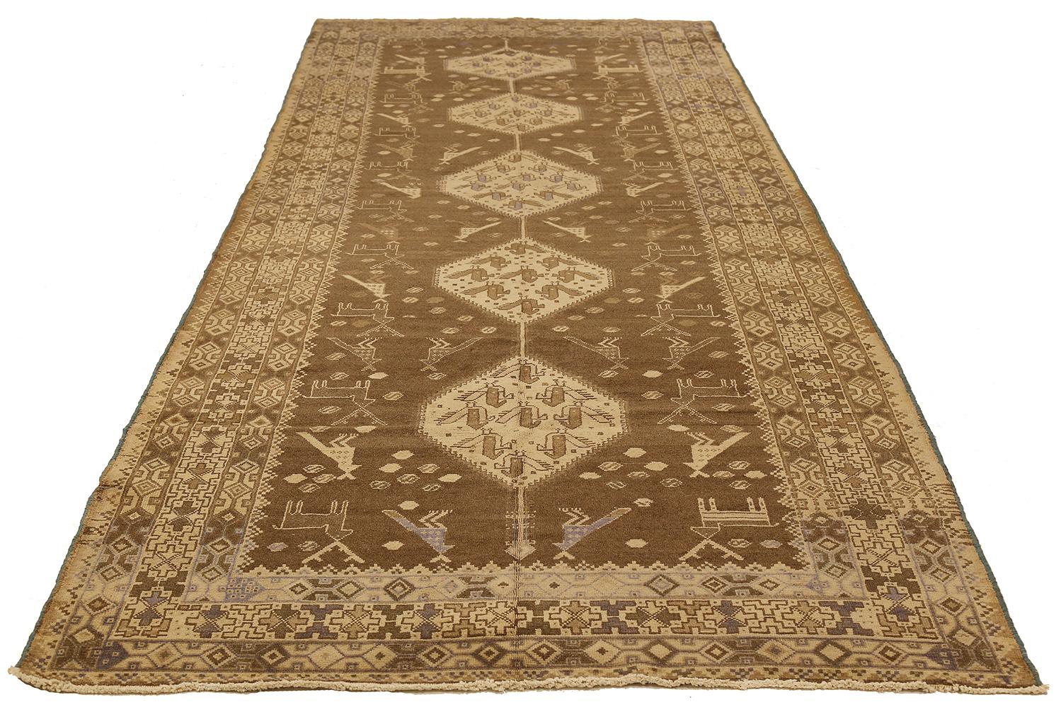 Antique Persian runner rug handwoven from the finest sheep’s wool and colored with all-natural vegetable dyes that are safe for humans and pets. It’s a traditional Malayer design featuring ivory and brown tribal details. It’s a lovely piece to