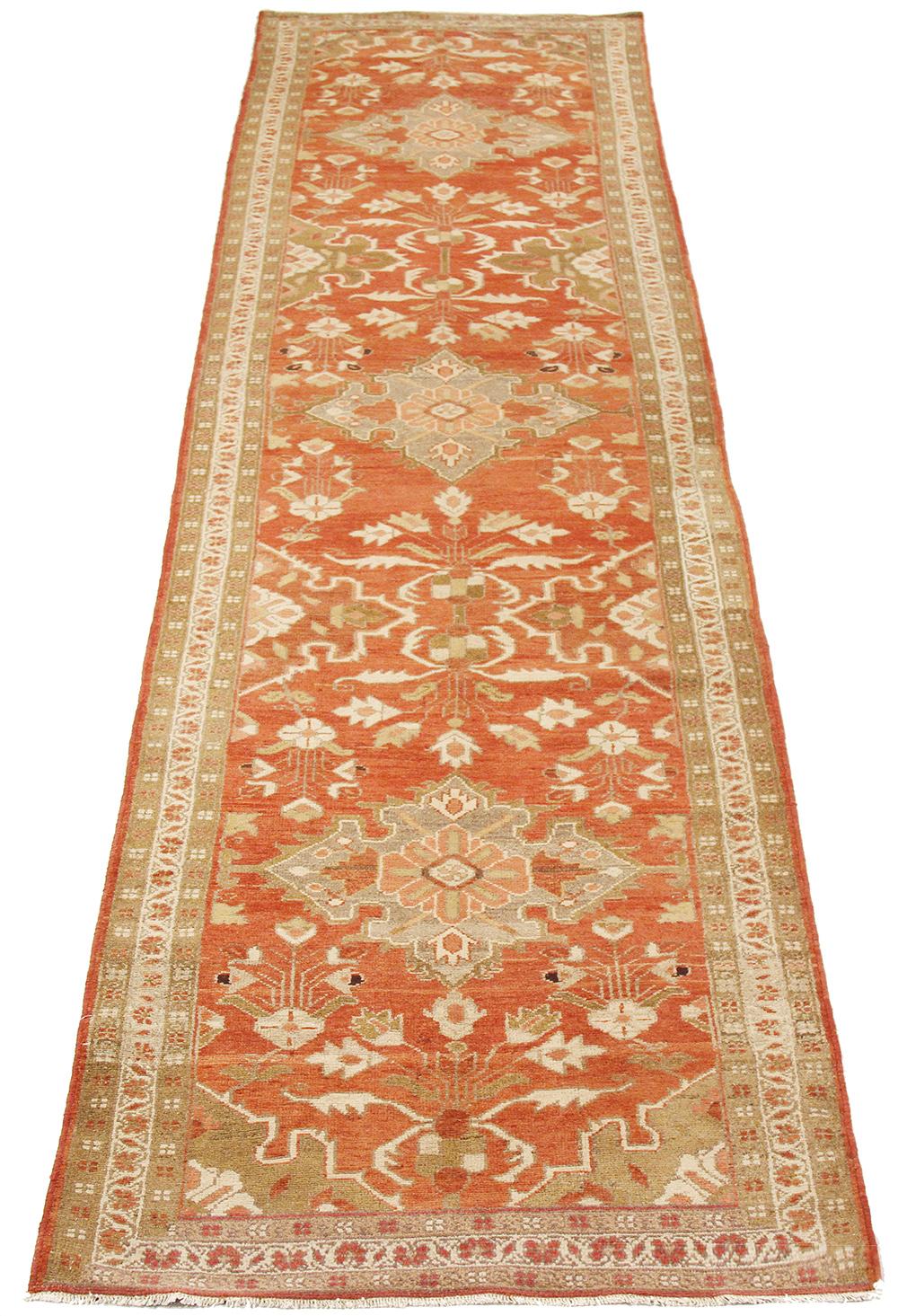 Antique Persian rug handwoven from the finest sheep’s wool and colored with all-natural vegetable dyes that are safe for humans and pets. It’s a traditional Malayer design featuring ivory and green floral details on a red field. It’s a lovely piece