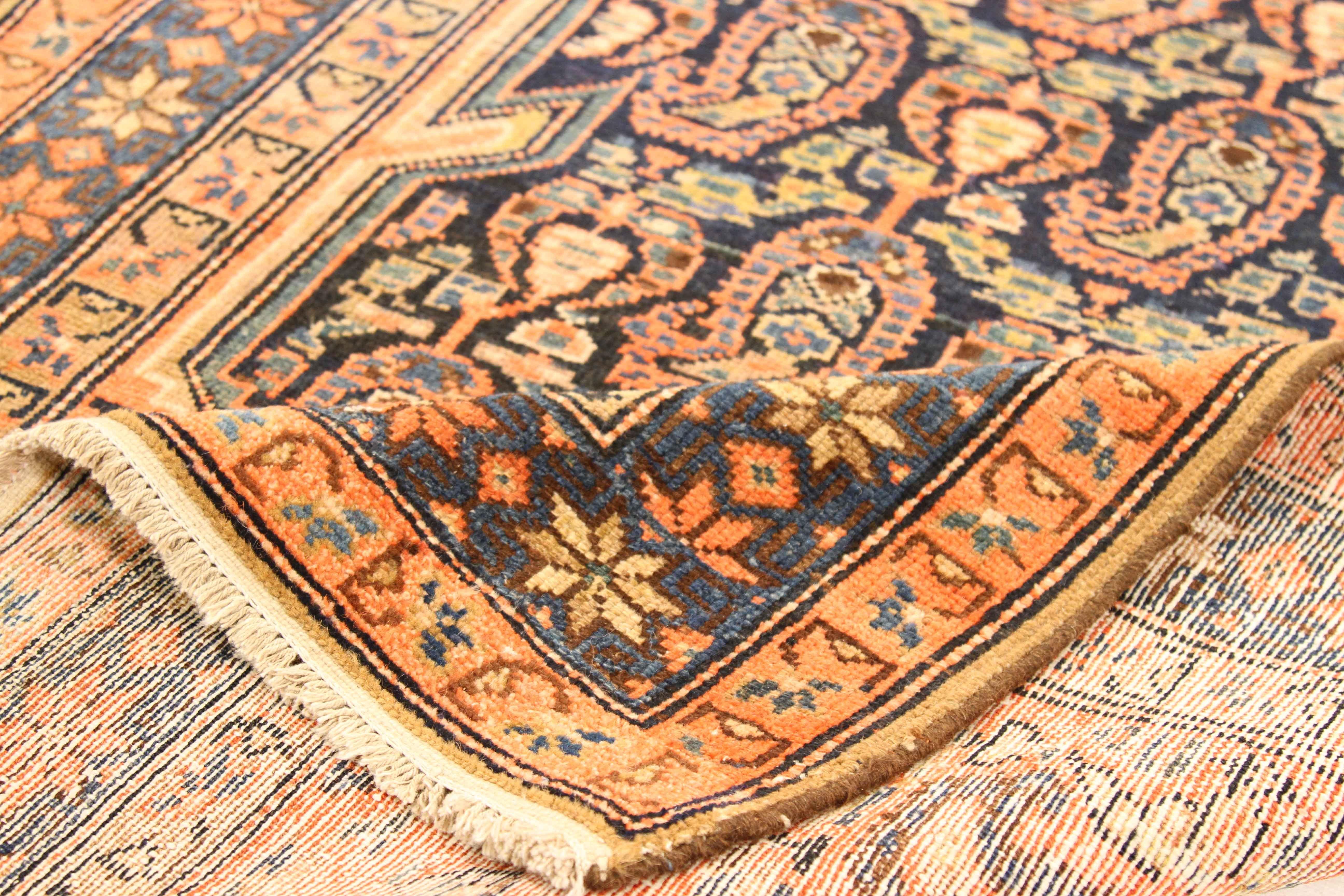 Antique Persian runner rug handwoven from the finest sheep’s wool and colored with all-natural vegetable dyes that are safe for humans and pets. It’s a traditional Malayer design featuring ‘Boteh’ details in ivory, pink and brown. It resembles a