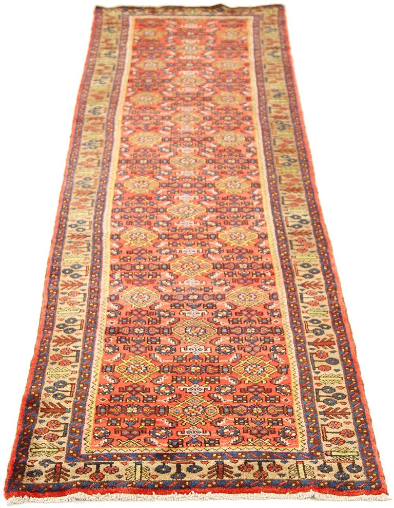Antique Persian rug handwoven from the finest sheep’s wool and colored with all-natural vegetable dyes that are safe for humans and pets. It’s a traditional Malayer design featuring yellow and blue floral details on a red field. It’s a lovely piece