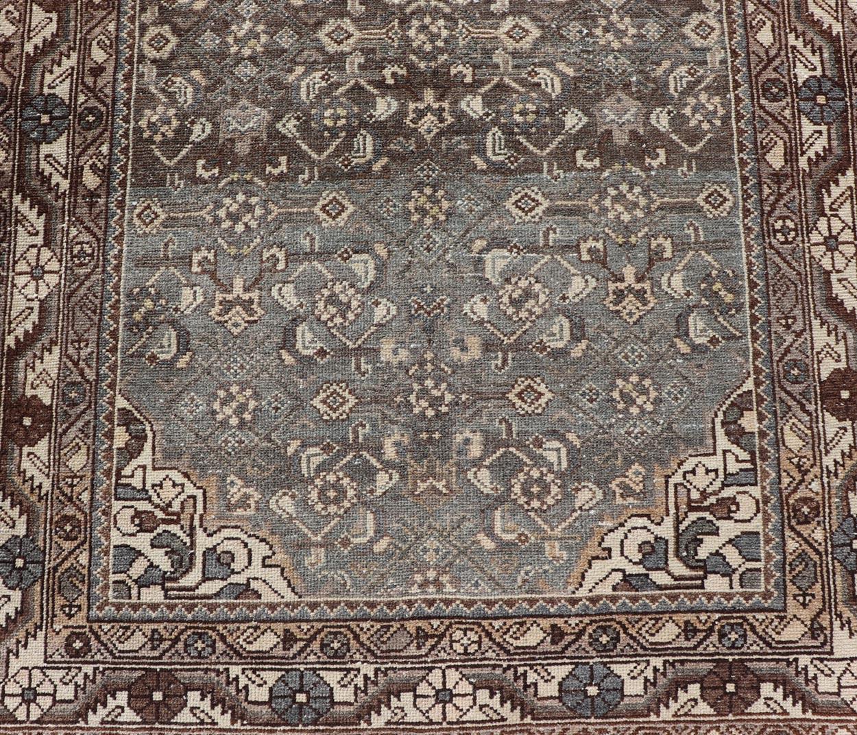 Measures: 3'6 x 10'3 

This antique Persian Malayer displays the Herati design, however this one-of-a-kind piece features a crisp borer in bright cream to boldly contrast with the brown and blue.. The field adopts the same palette, using brown and