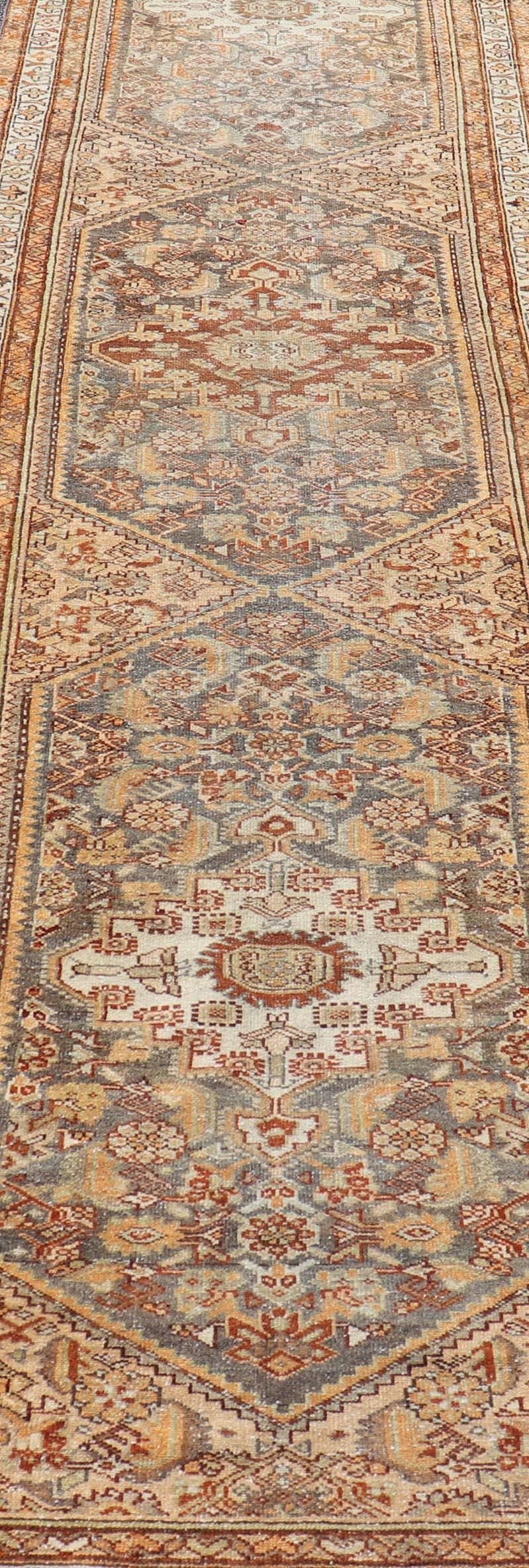 20th Century Antique Persian Malayer Runner with All-Over Sub-Geometric Medallion Design For Sale