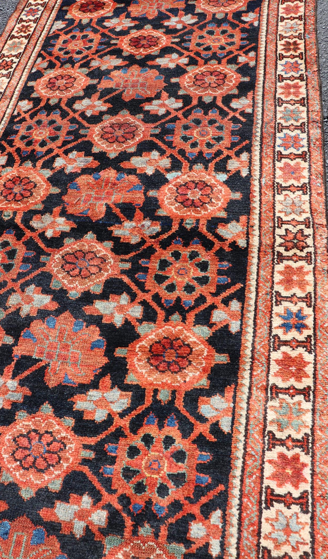 Wool Antique Persian Malayer Runner with Reds and Oranges on a Charcoal Background For Sale