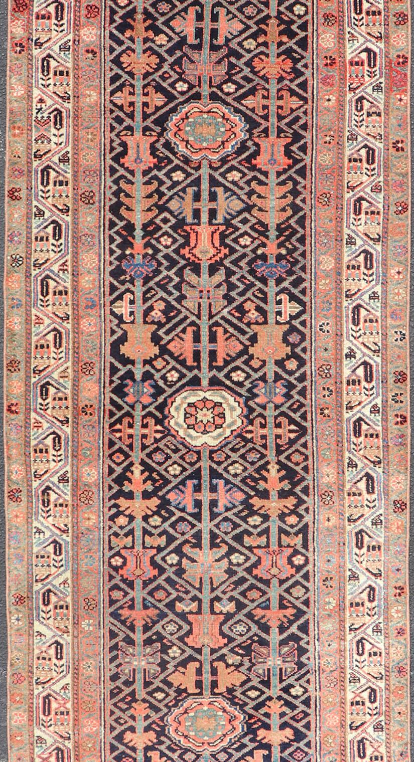 Malayer antique runner from Persia with geometric floral central field design, rug ZIR-58-KV-04, country of origin / type: Iran / Malayer, circa 1910.

This antique Persian Malayer runner, circa early 20th century, relies heavily on exquisite