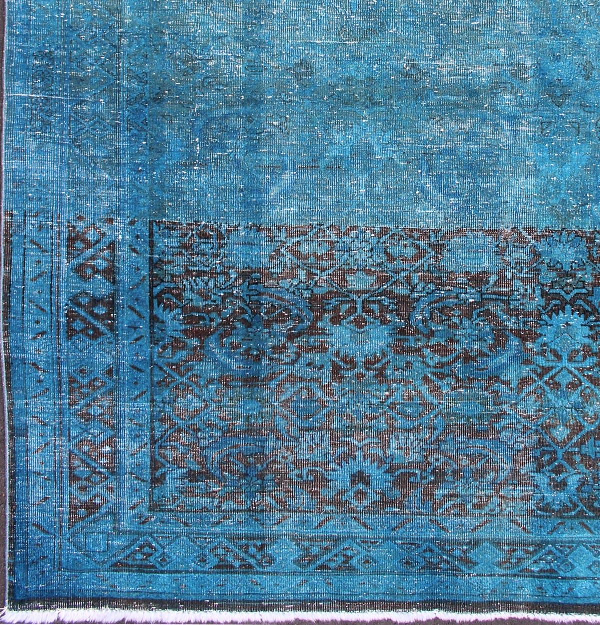 This beautiful antique Malayer rug from Iran was handwoven and bears a remarkably unique all-over design rendered in tones of blue. The combination of its early period creation and its one-of-a-kind design makes this a rare and desirable