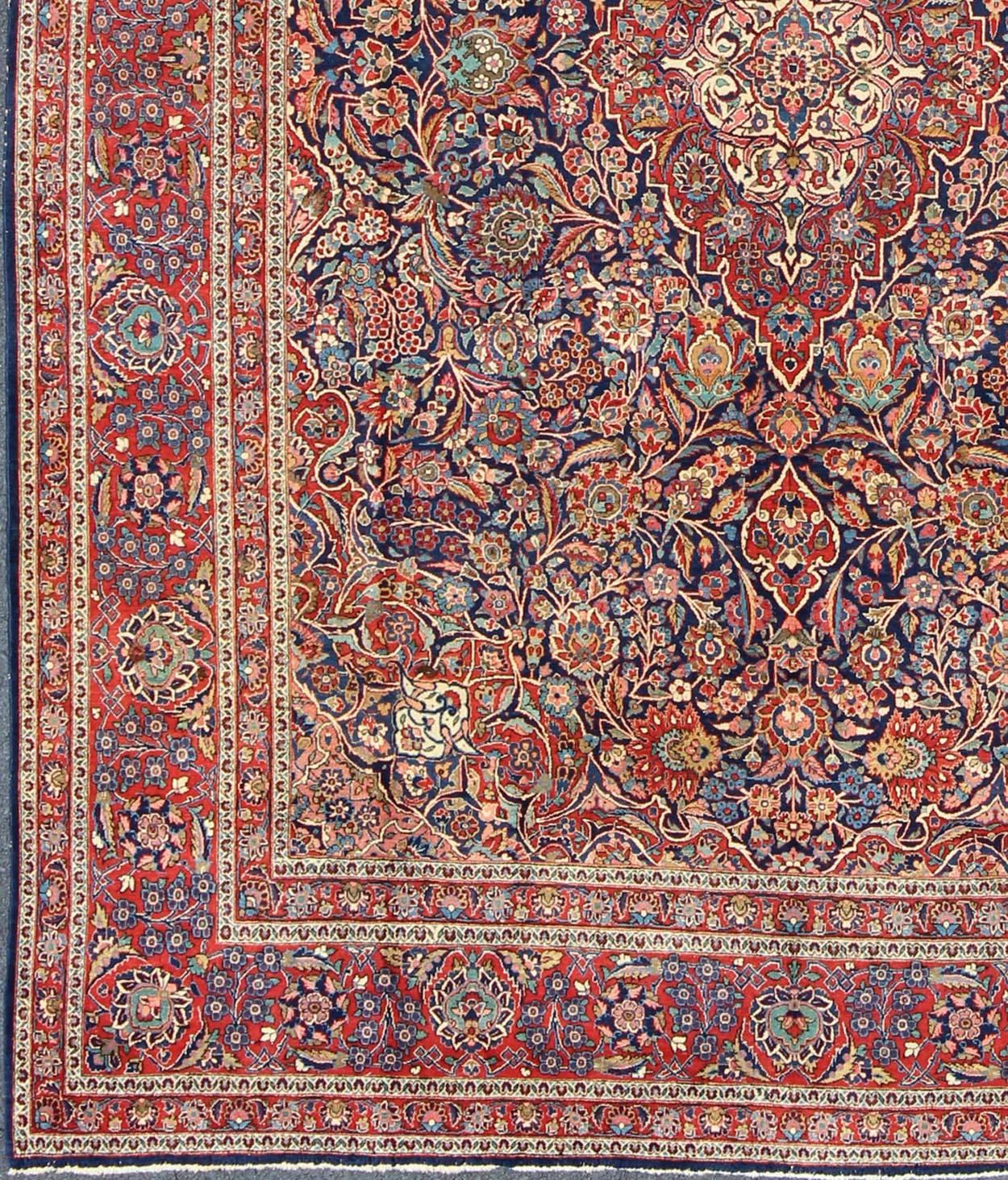 Fine Kashan Red and blue antique Persian Manchester wool Kashan rug with Arabesque blossom design, rug 11-90401, country of origin / type: Iran / Kashan, circa 1910
 Gorgeous antique rug (circa 1910). Madder red and indigo blue set the attractive