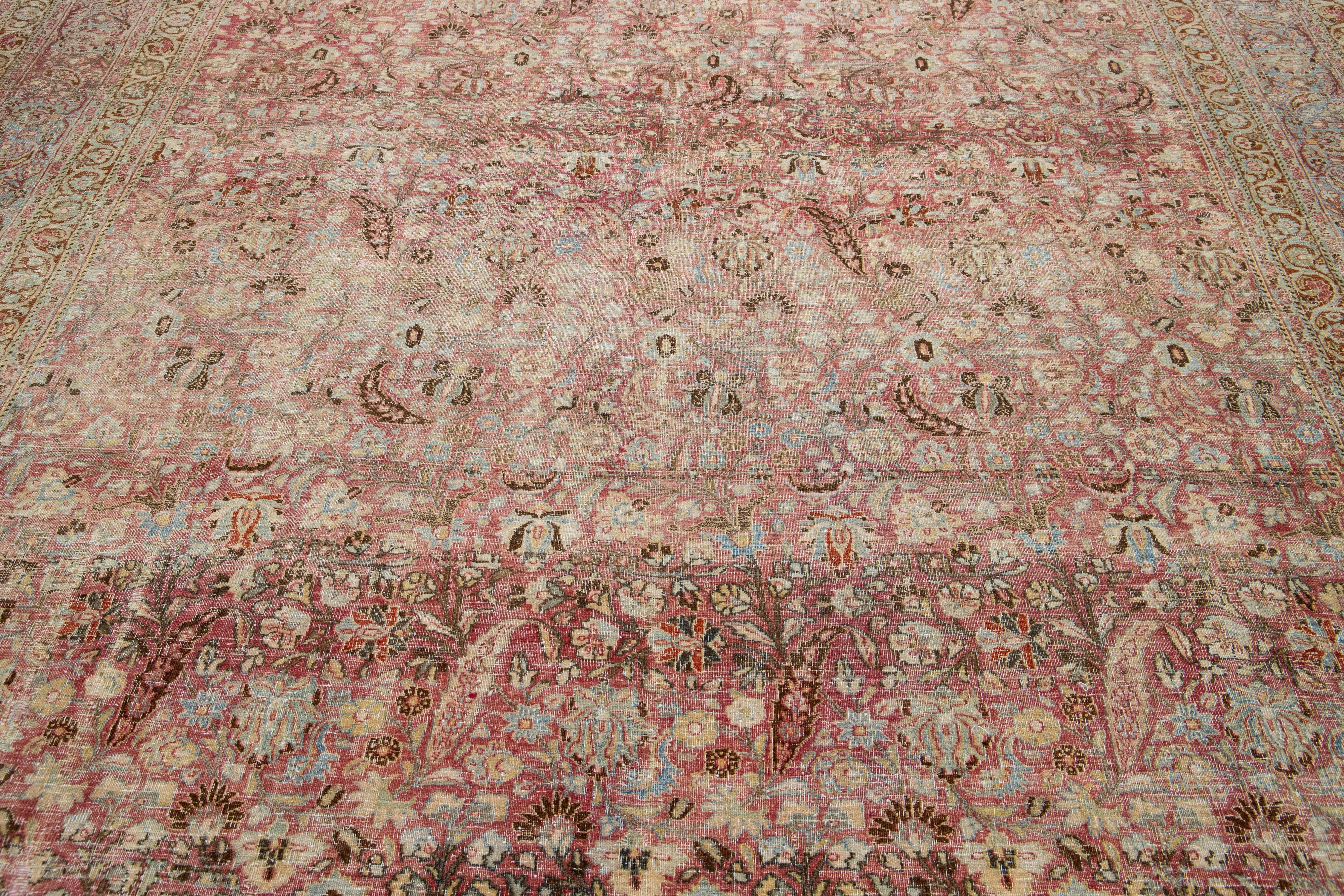 20th Century Antique Persian Mashad Handmade Red Wool Rug with Allover Floral Design For Sale